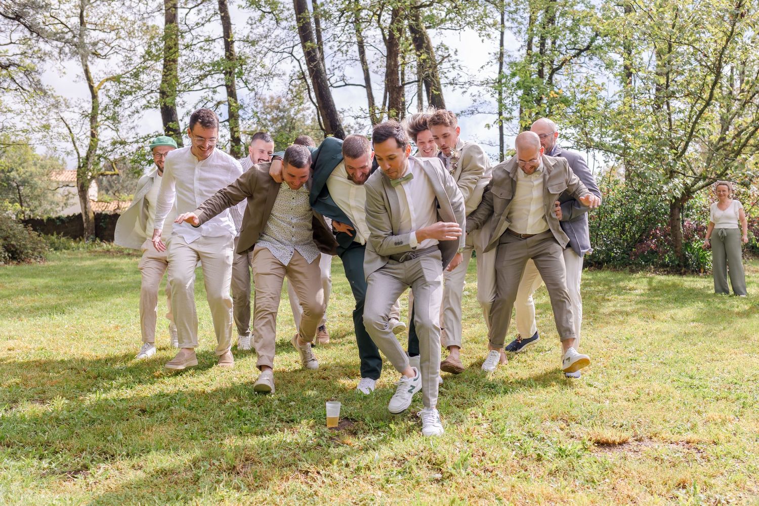 Group celebrating outdoors in light colored casual suits and dress clothes.