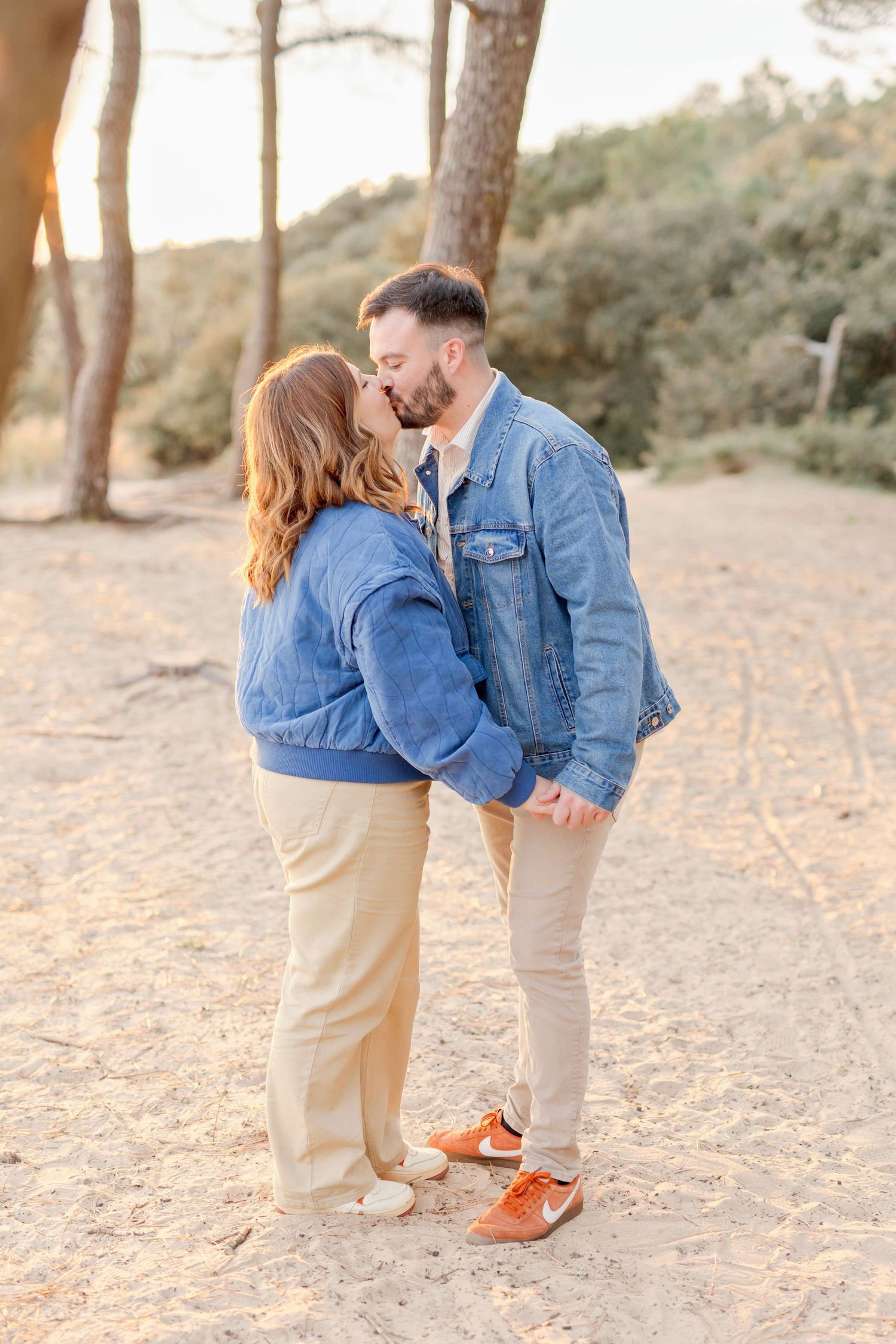 Full-body shots of couple in denim and khaki sharing sweet moments on beach.