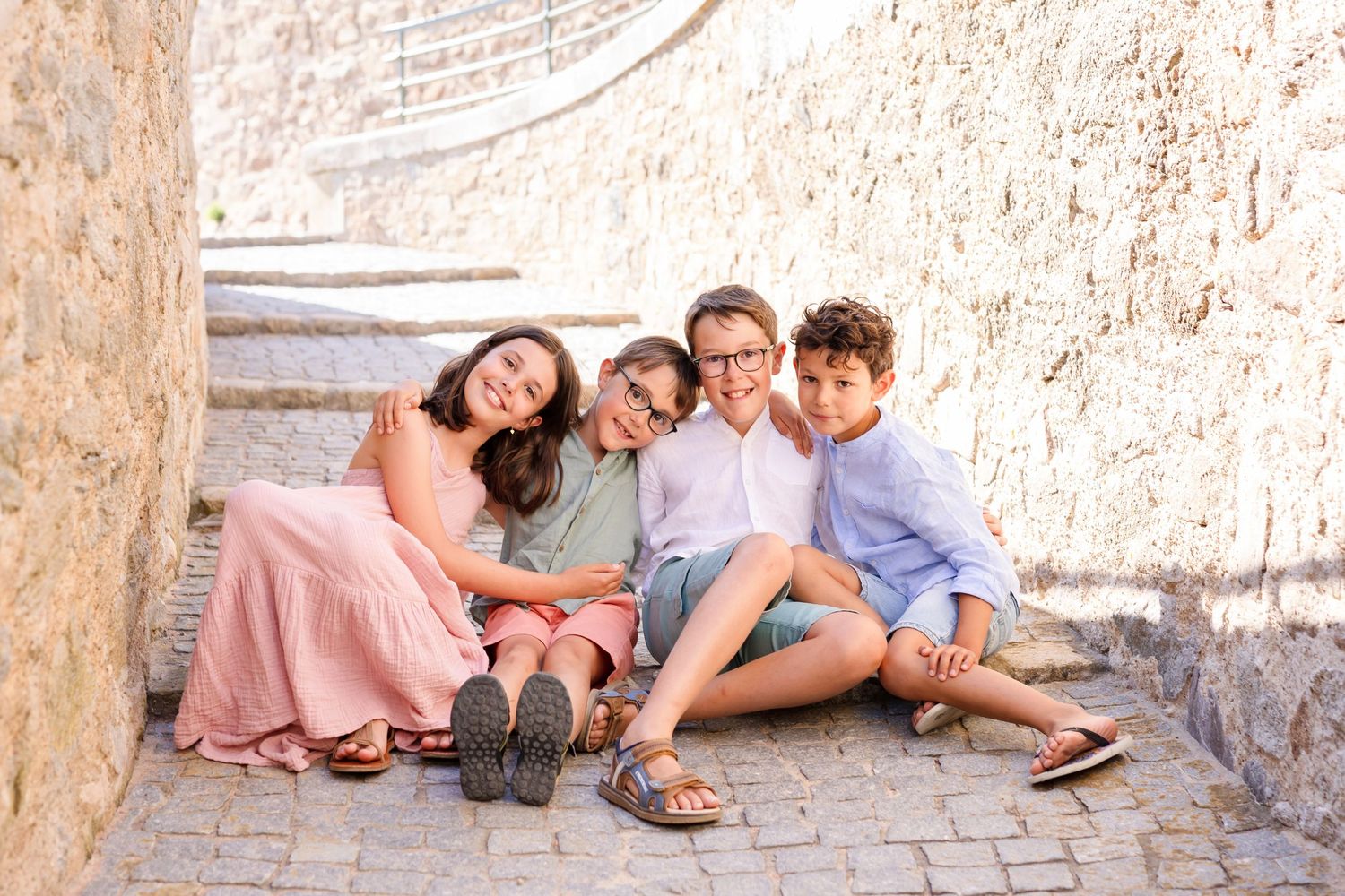 People sitting together on stone steps during an outdoor photoshoot.