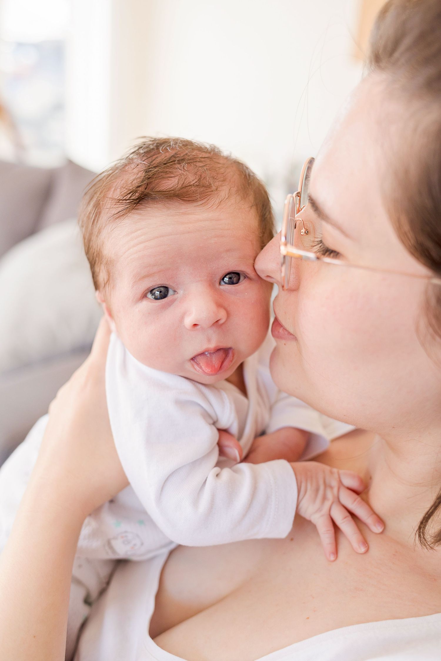 Close-up series showing sweet bonding moments with a baby in white.