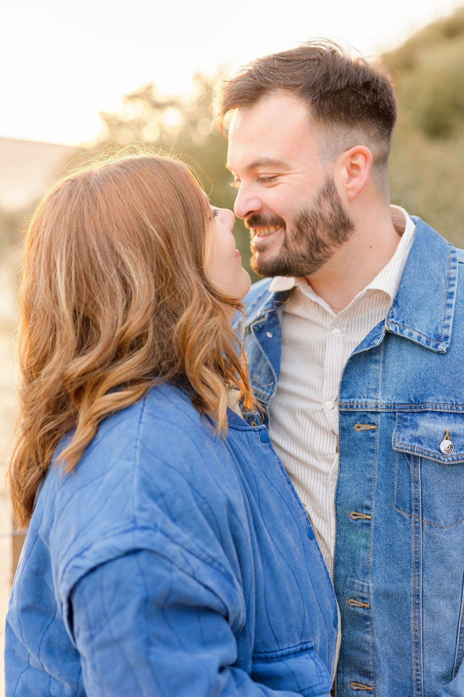 Intimate portrait of couple in denim and cream colors during golden hour.