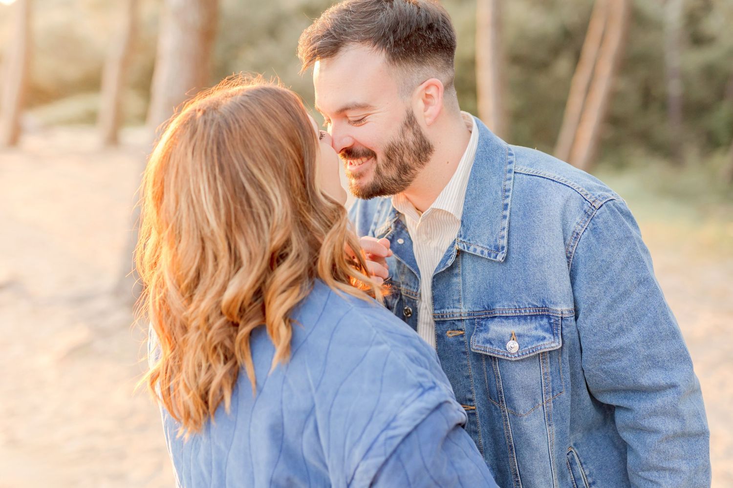 Candid moments of couple in denim jackets against sunset beach backdrop.