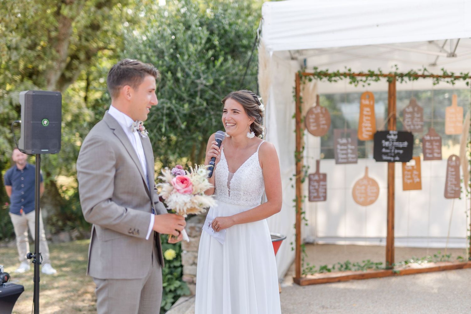 Wedding ceremony setup under white gazebo with floral decorations.
