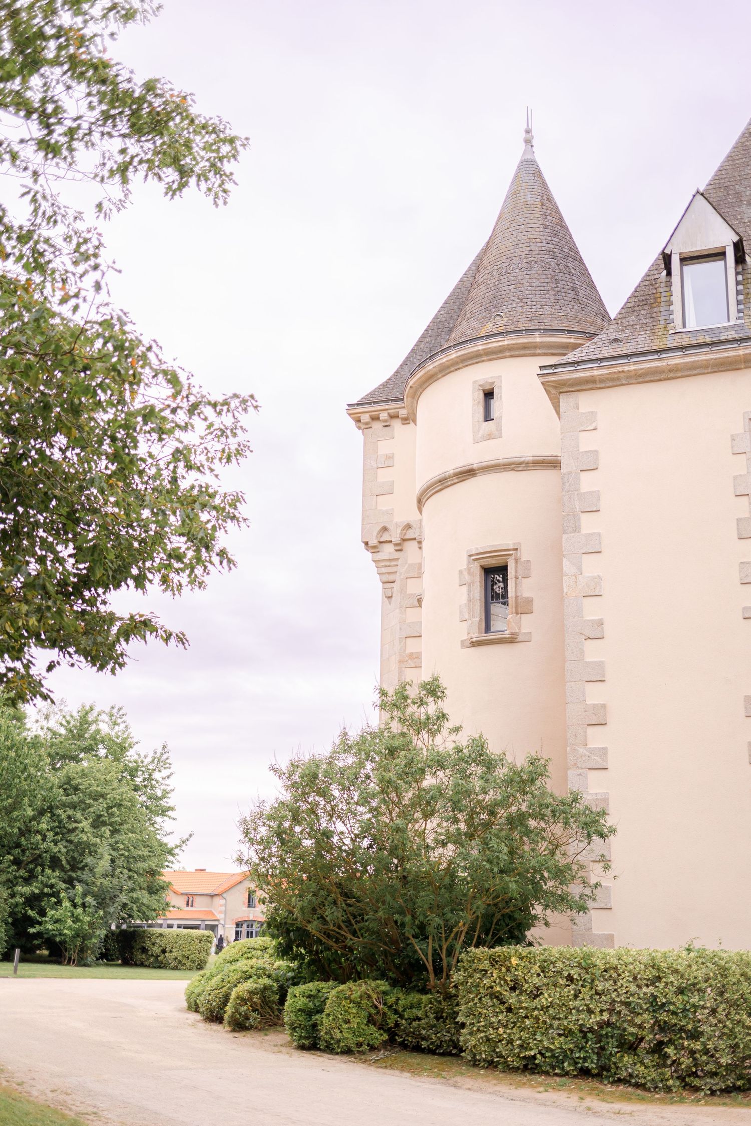 Majestic castle tower with cone-shaped turret and cream-colored stone walls.