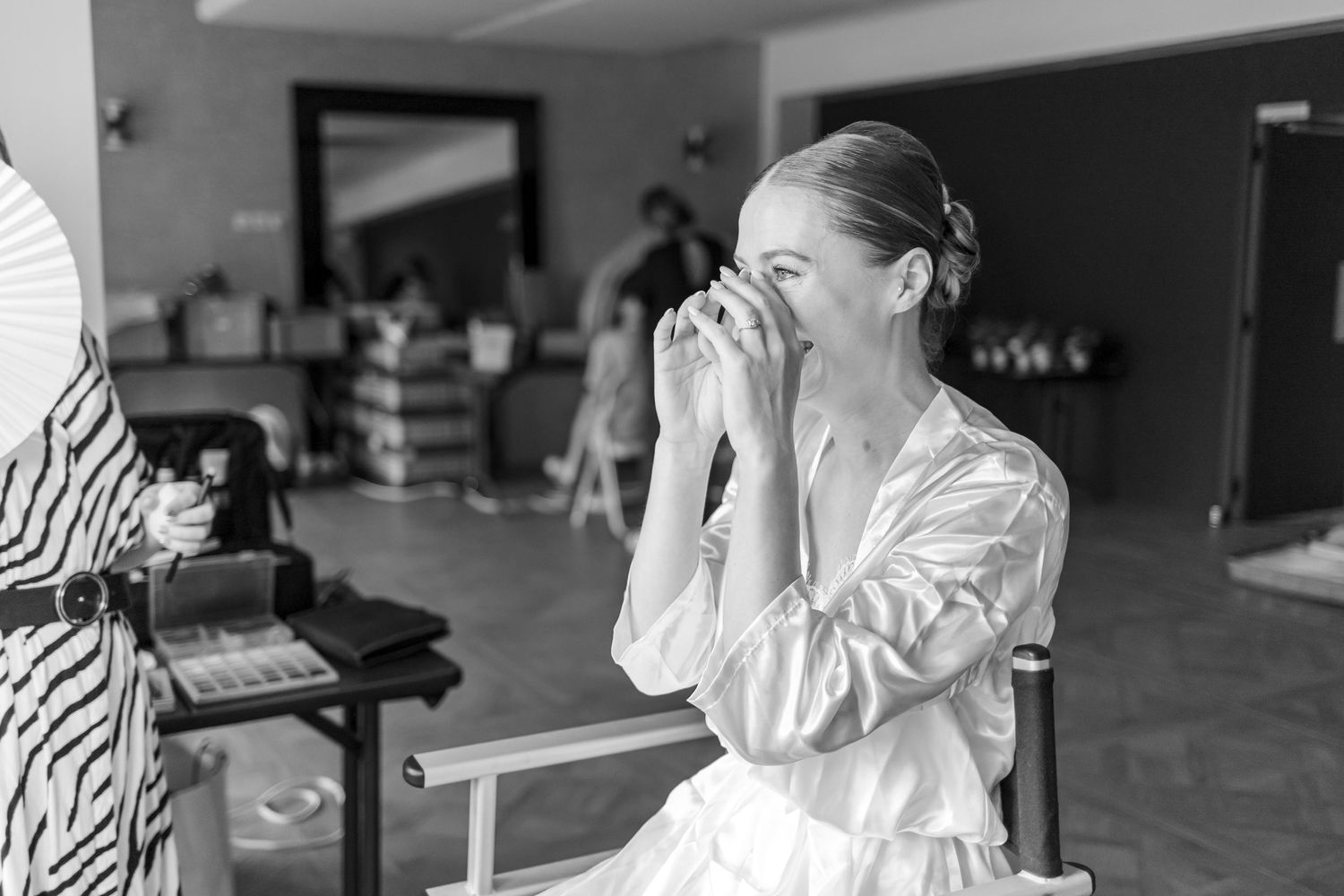 Emotional black and white moment captured during wedding day preparations.