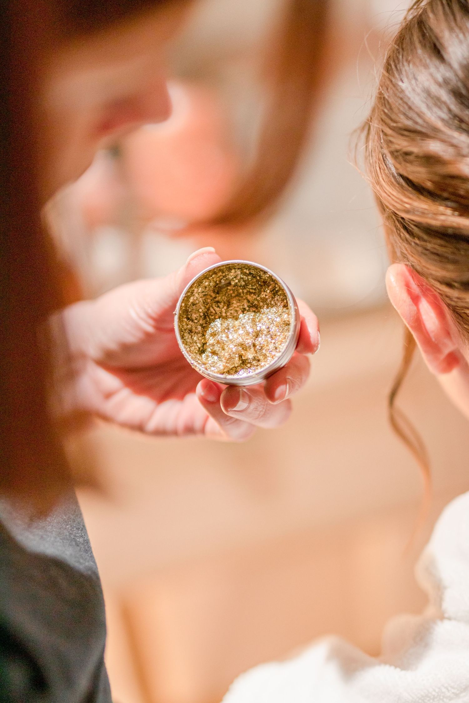 Wedding preparation scene showing gold accessories being placed in hair.