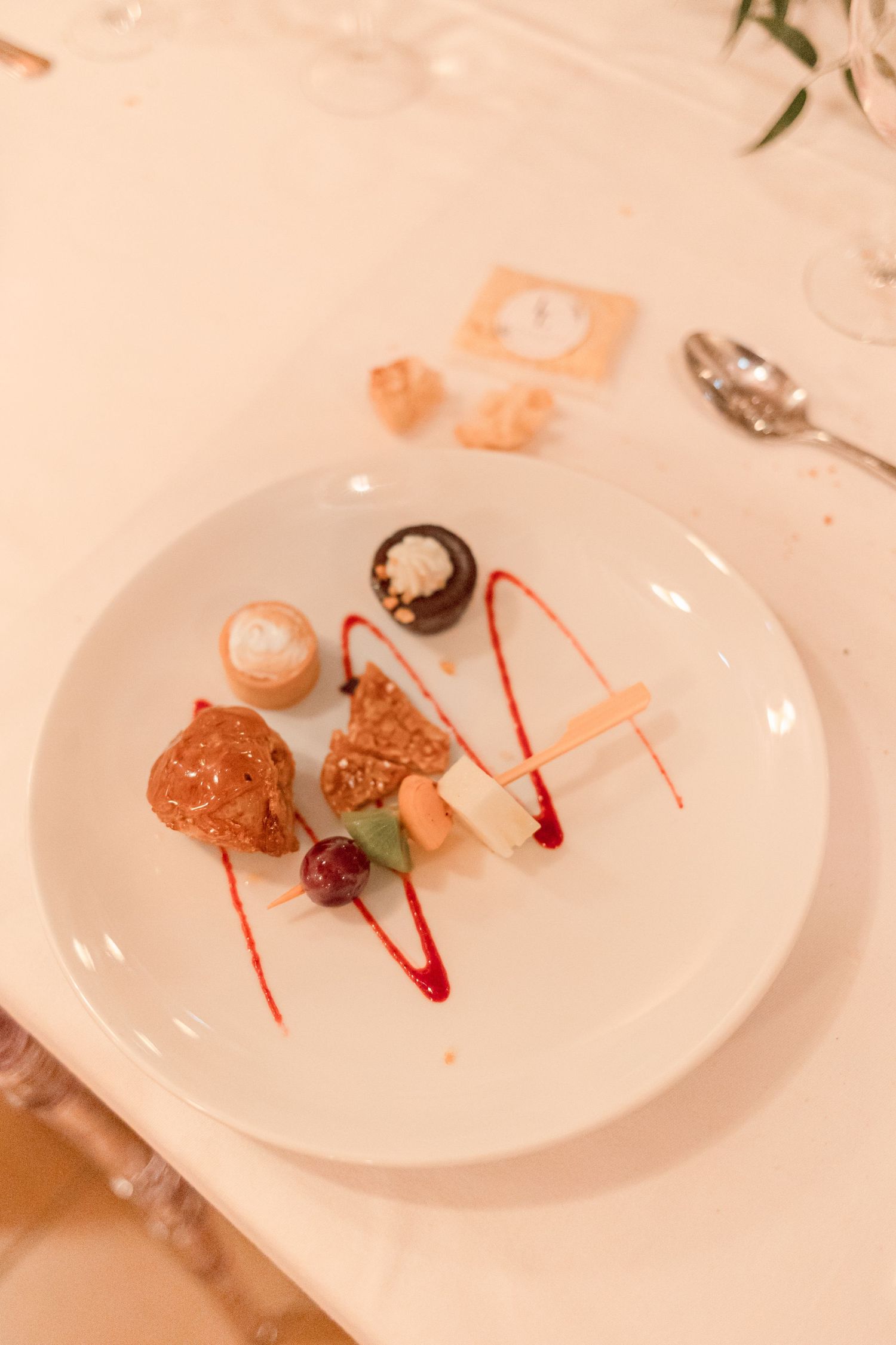 Artfully plated desserts with red sauce accents on white china plates.