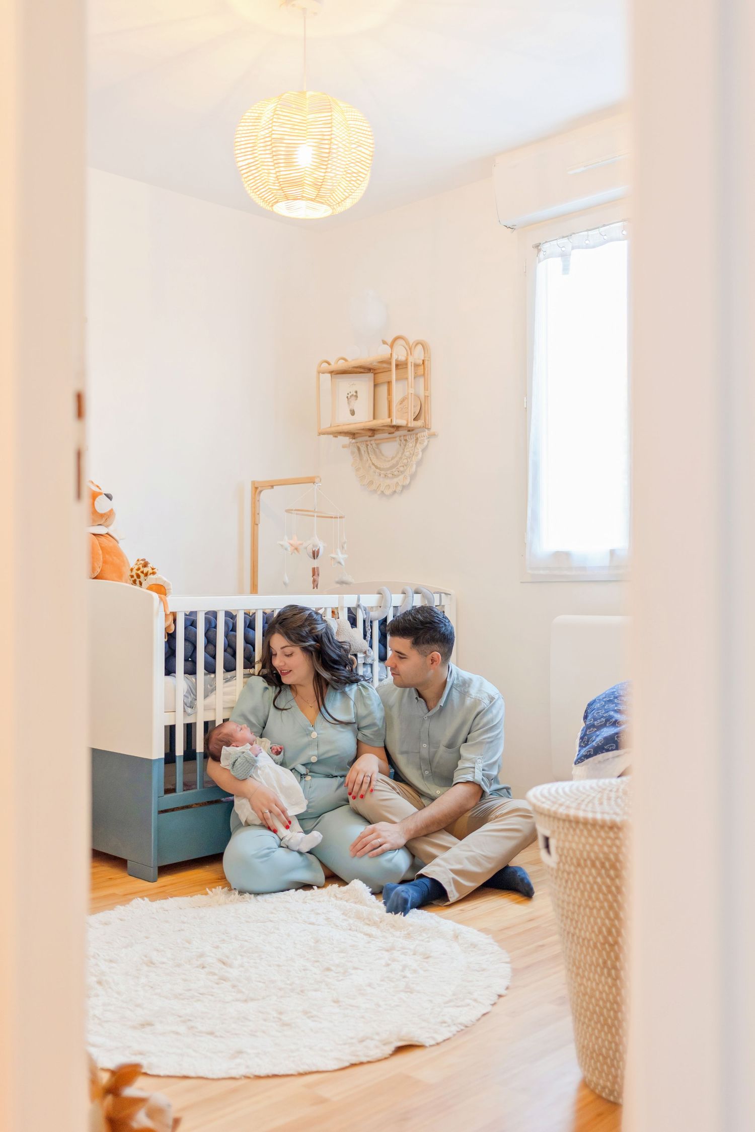 A cozy nursery scene with a blue crib, round rug, and soft lighting creating a peaceful atmosphere.