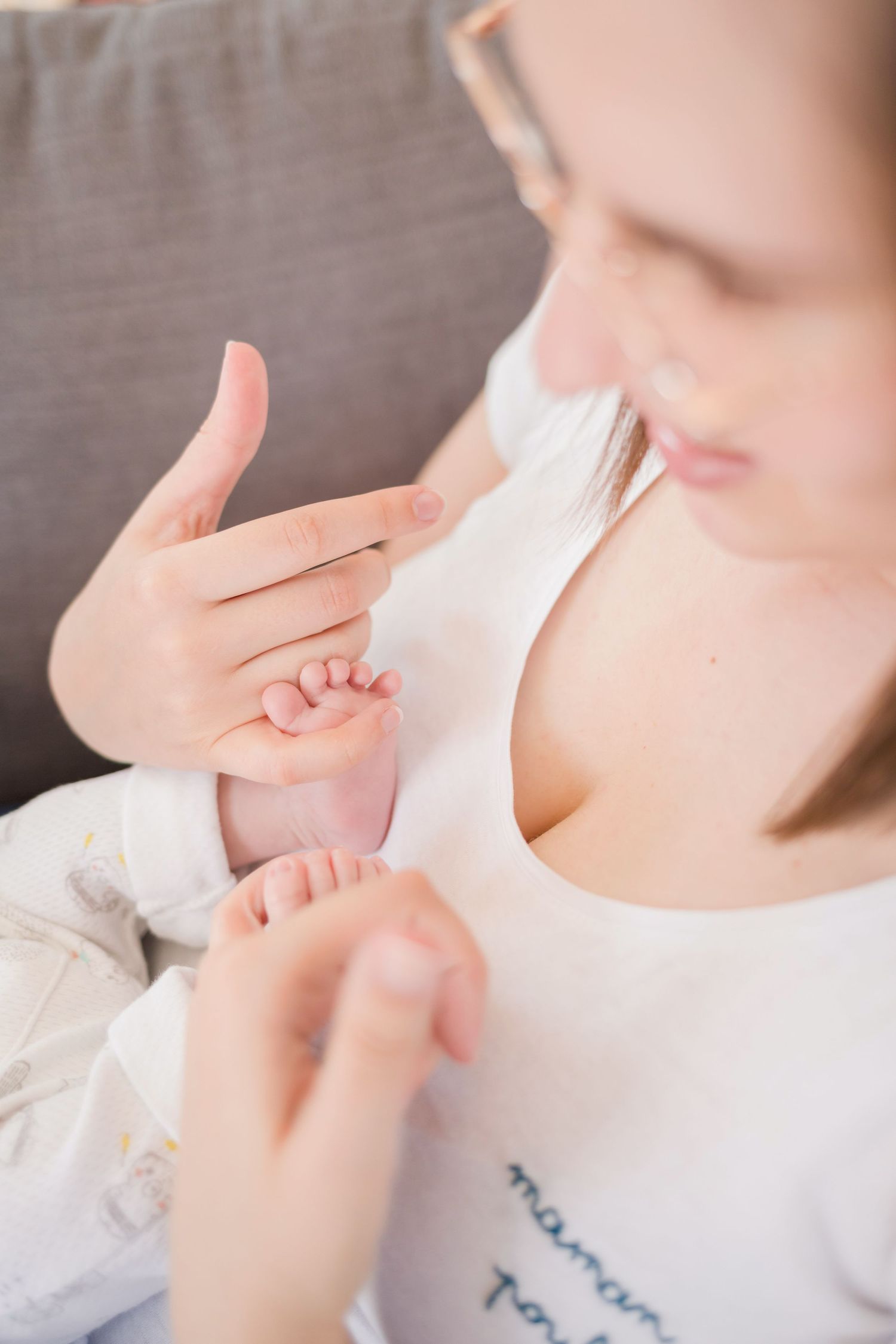 Delicate close-up showing hands and tiny baby feet.