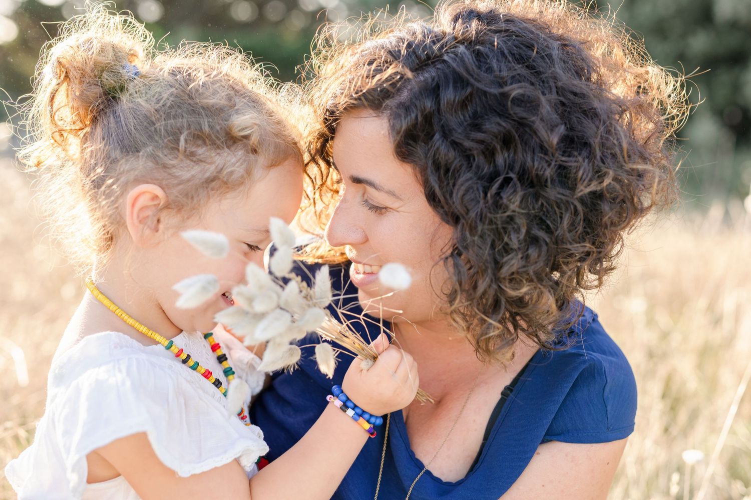 Sweet interaction between parent and child among wildflowers at sunset.