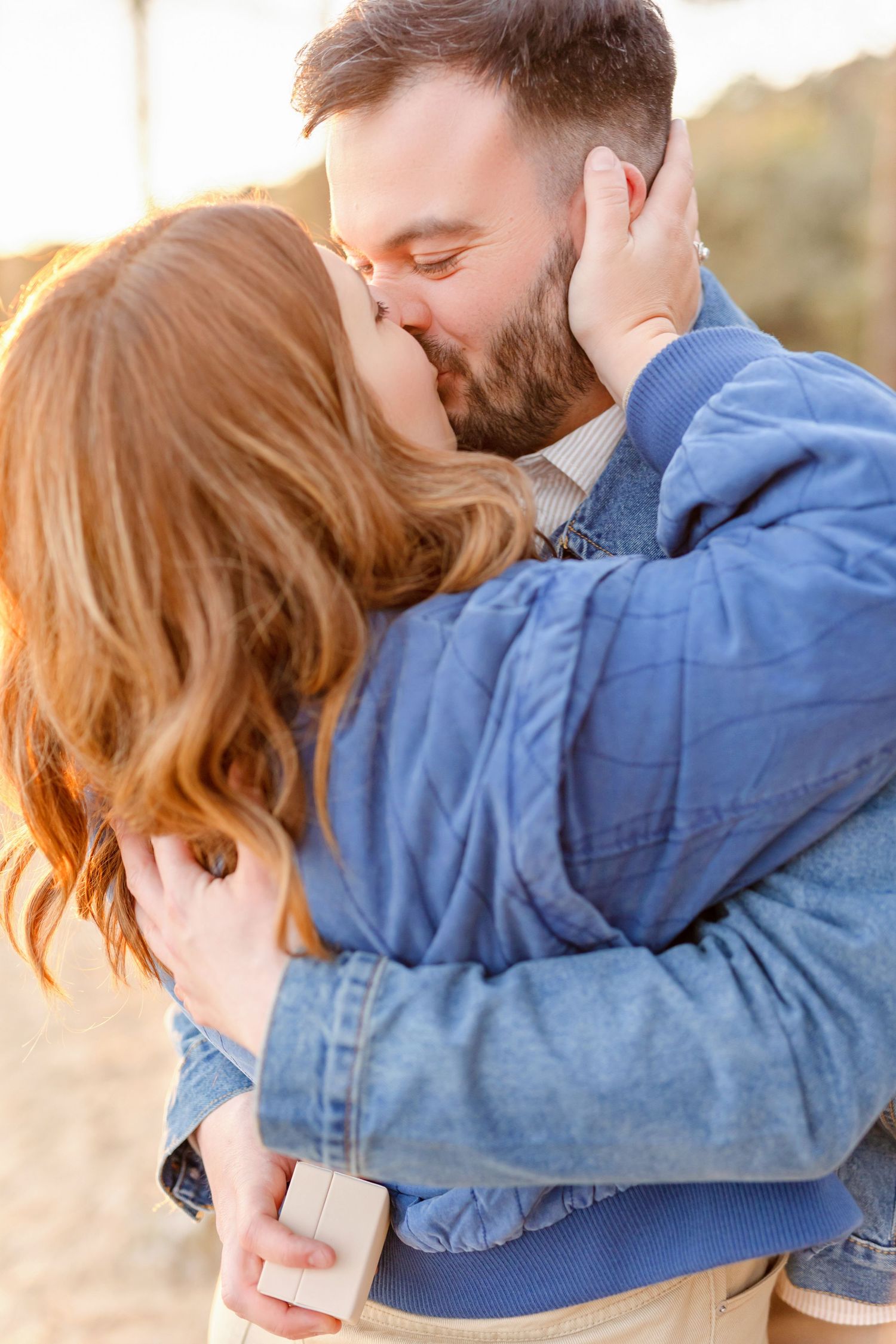 An intimate moment captured between two people in denim during golden hour.
