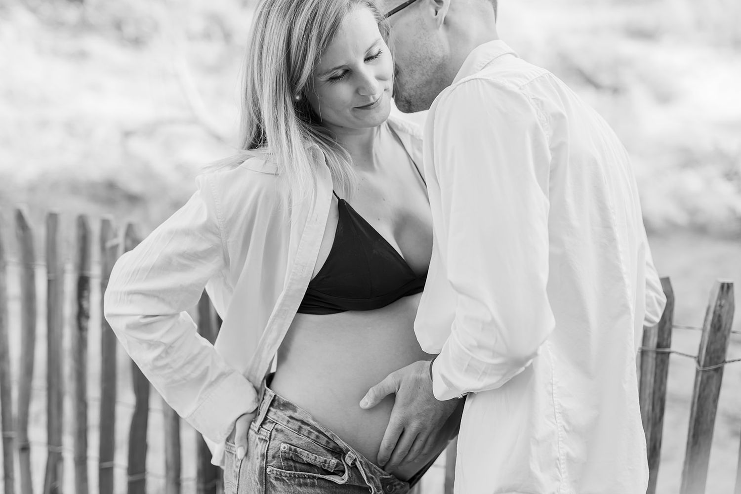 A black and white photo series shows happy moments of a couple in an outdoor setting.