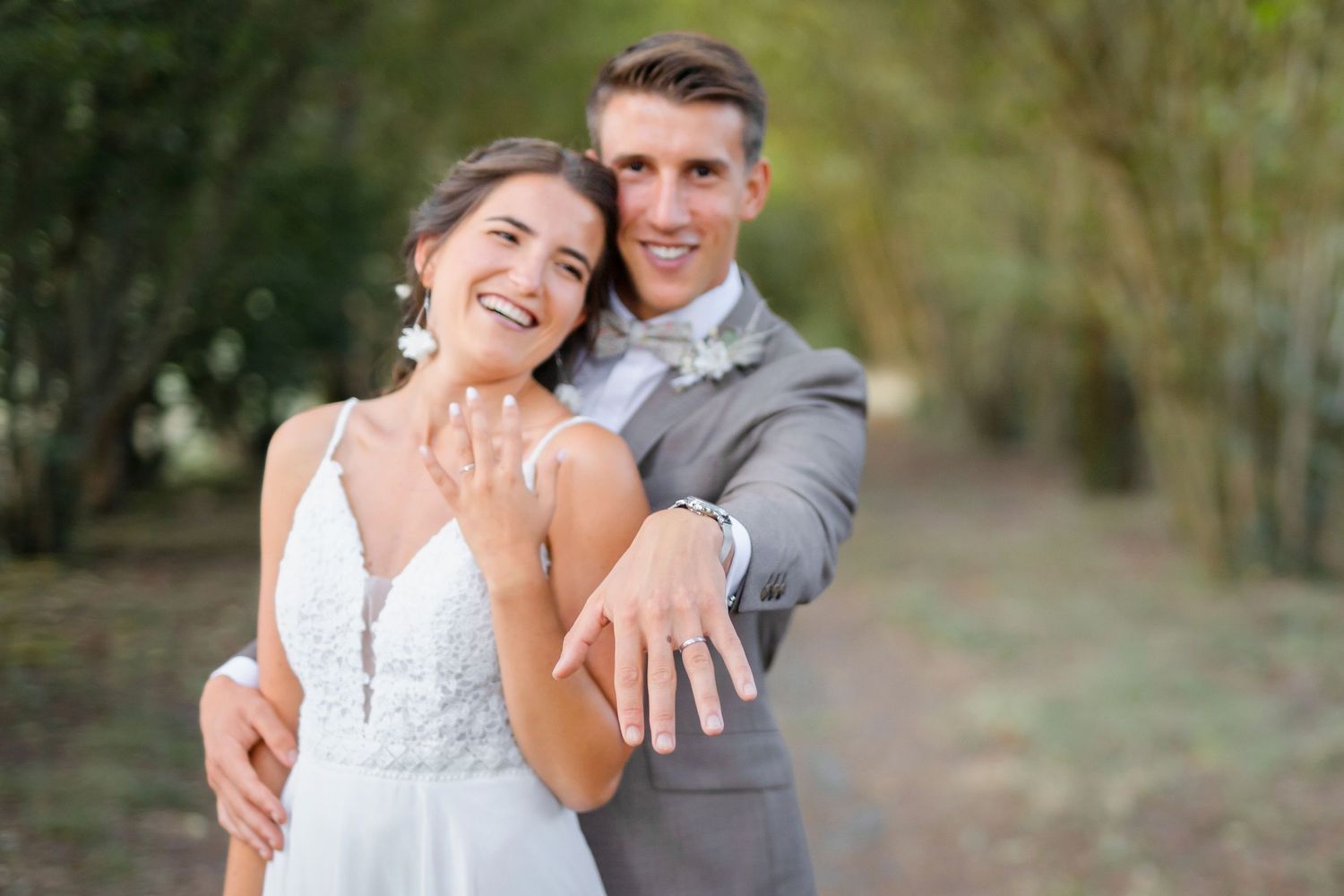 Happy wedding couple poses for playful sequence of portraits outdoors in natural setting.