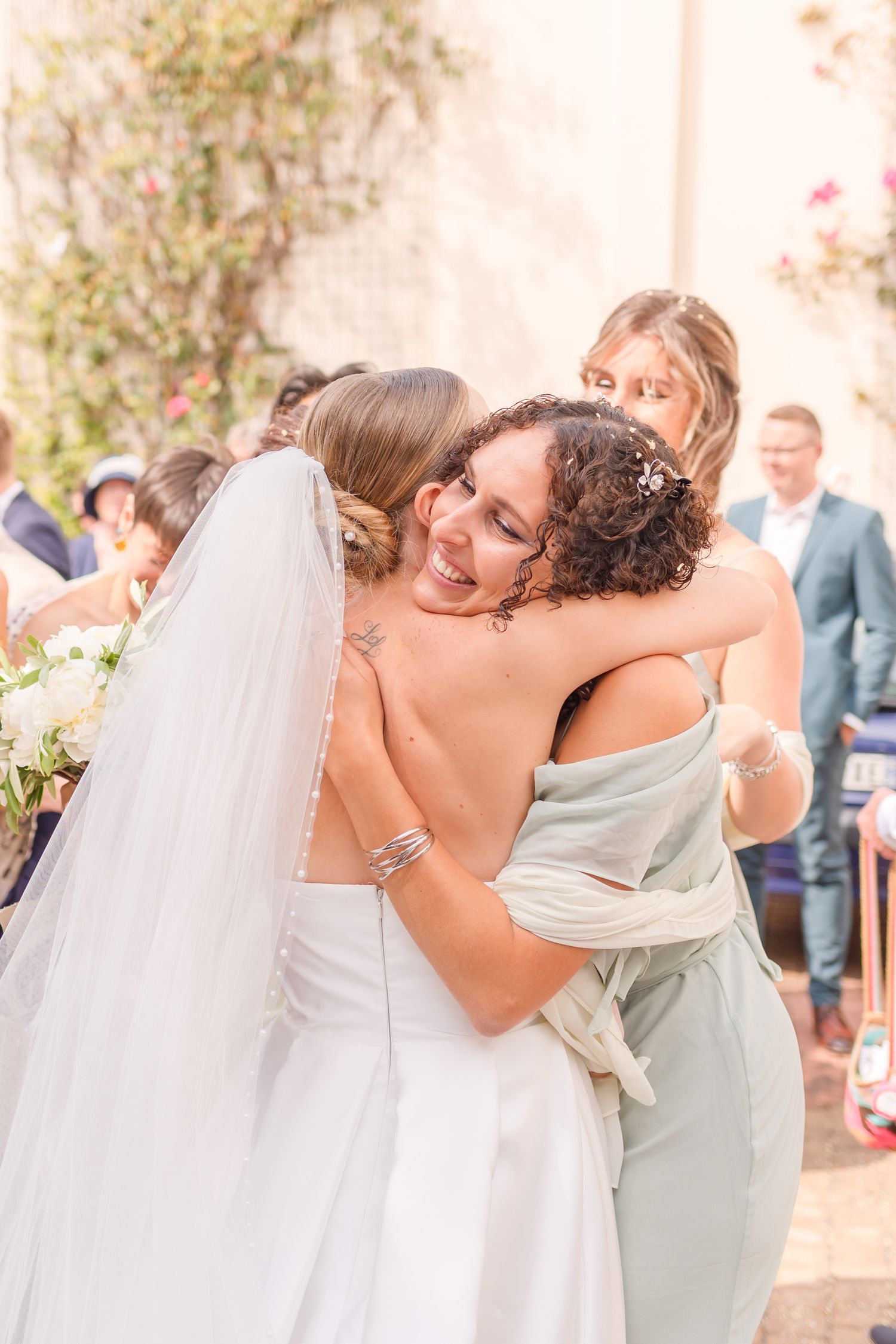 Emotional wedding guests share heartfelt hugs and congratulations during the celebration.