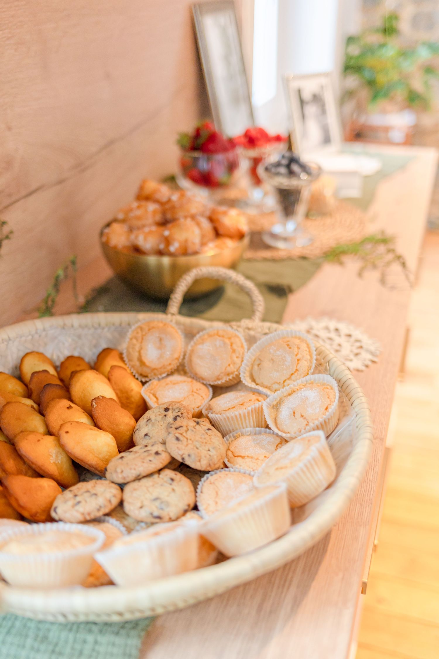 Assorted sliced bread and pastries arranged on a white platter at a buffet table.
