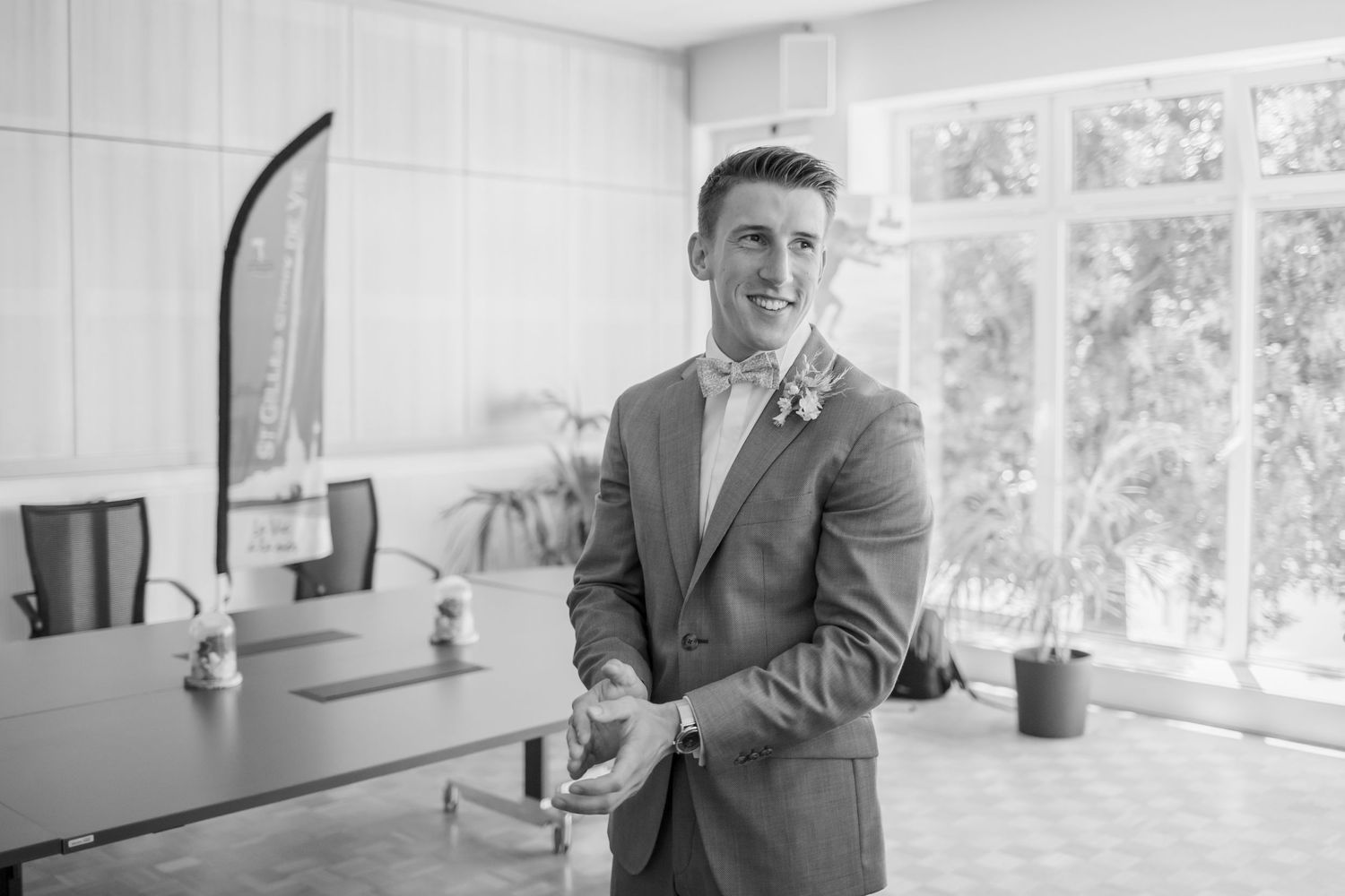 Interior wedding venue setting with bright windows and joyful candid moments.