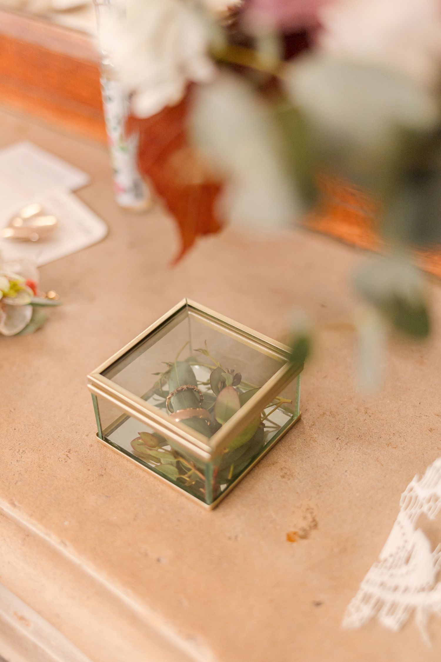 Close-up shots of gold glass terrariums and delicate wedding table decor.