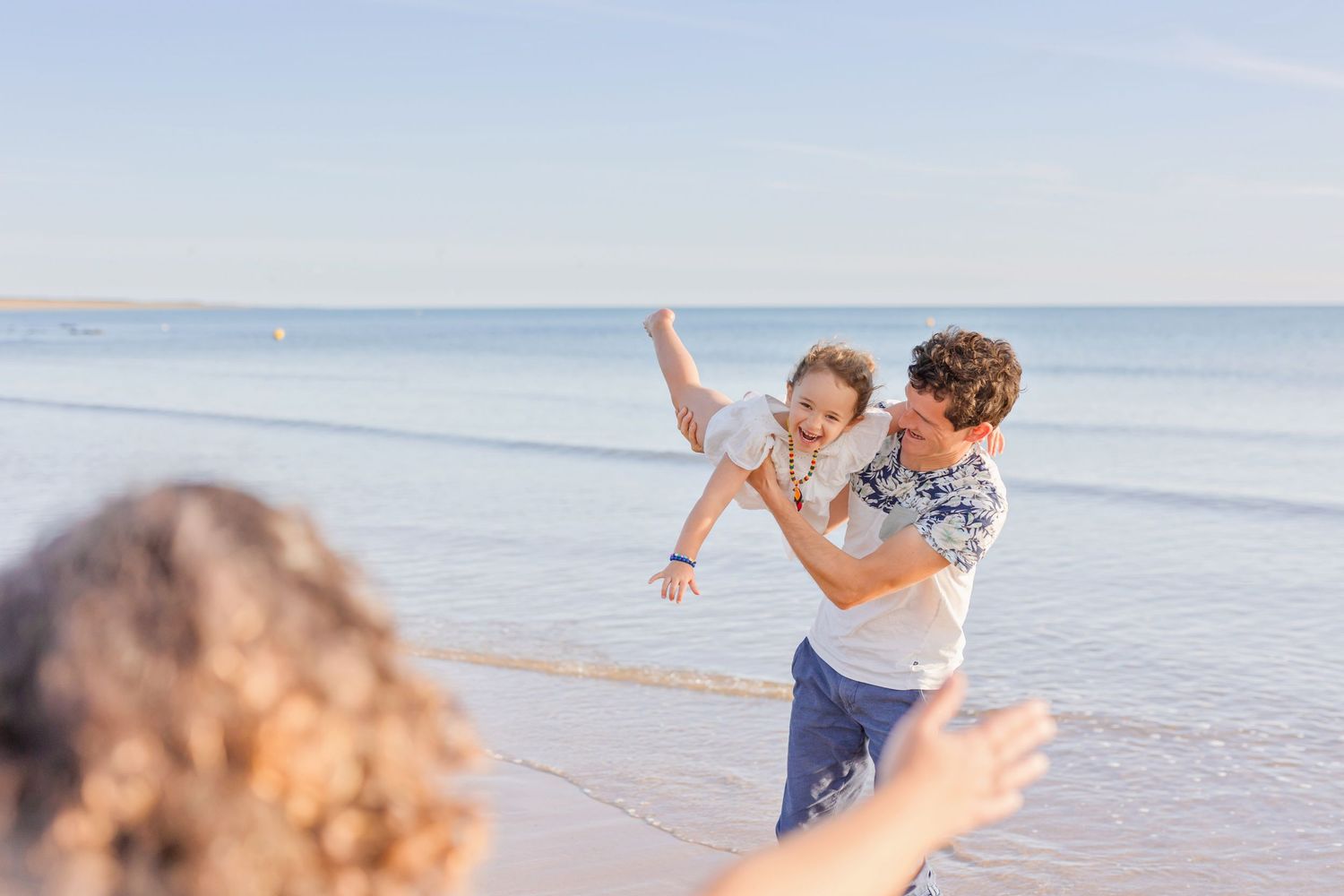 Playful beach moments with laughter and fun by the ocean.