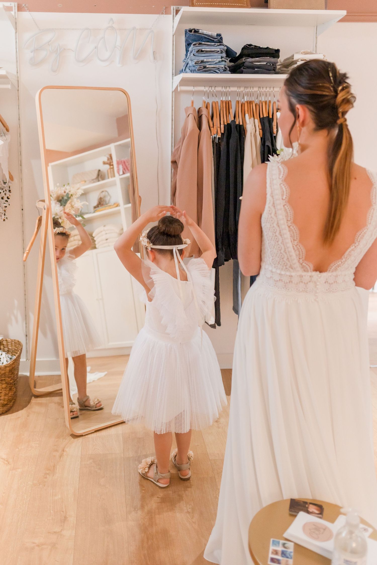 Wedding dress shopping experience showing various white gowns in a bridal boutique.