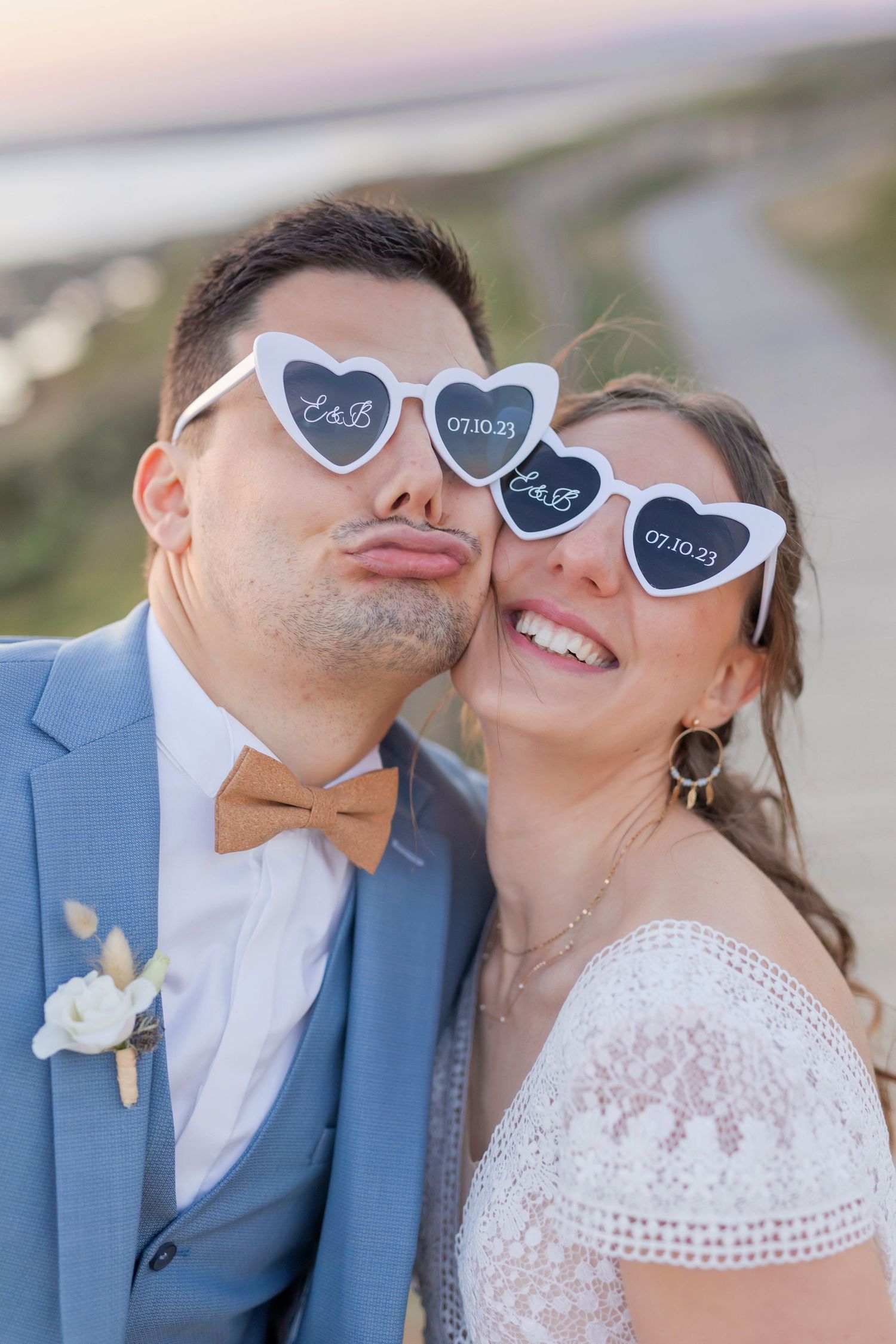 Bride and groom wearing heart-shaped sunglasses share playful moments on their wedding day.