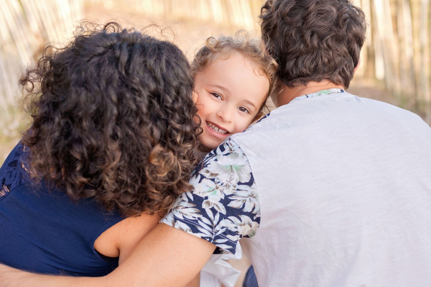 A sweet embrace shared on a sunny beach day while playing together.