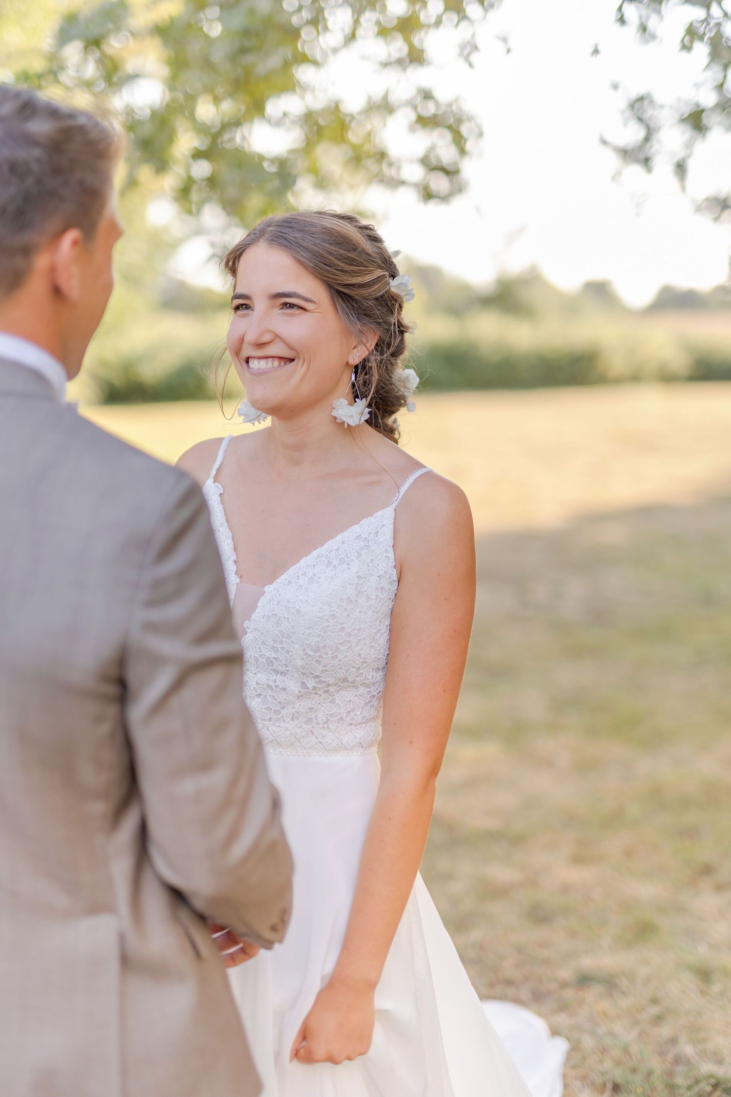 Romantic golden hour portrait of couple sharing joyful moment in outdoor setting.