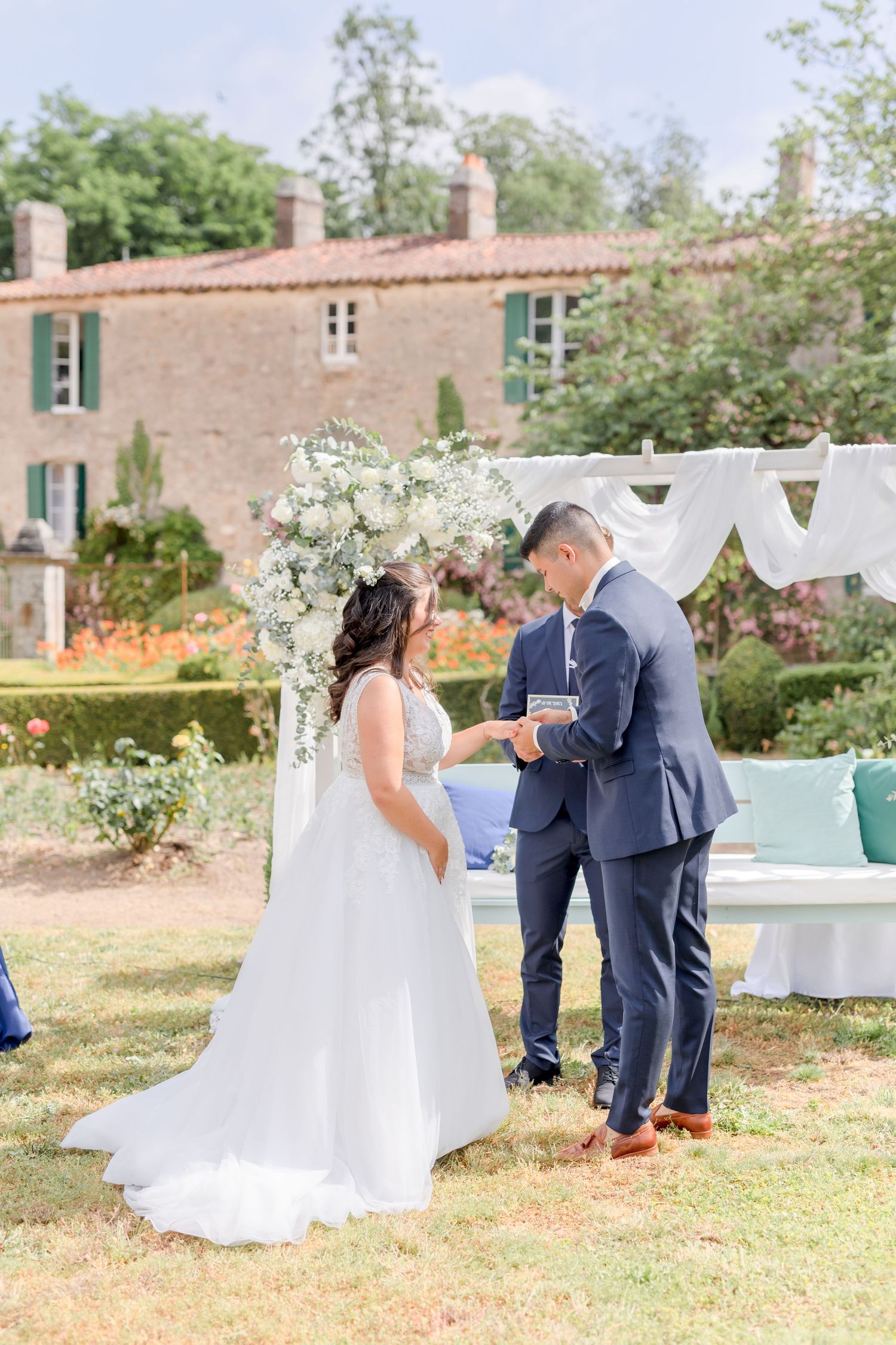 Couple shares emotional first look moment in garden setting with soft natural lighting.