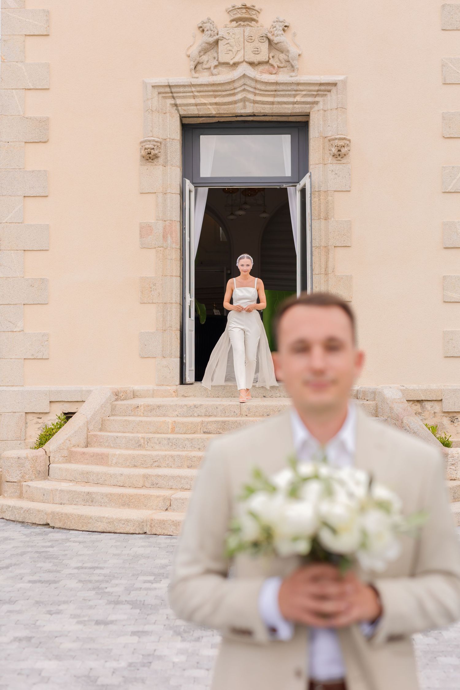 Wedding first look sequence outside classic stone building with elegant steps.