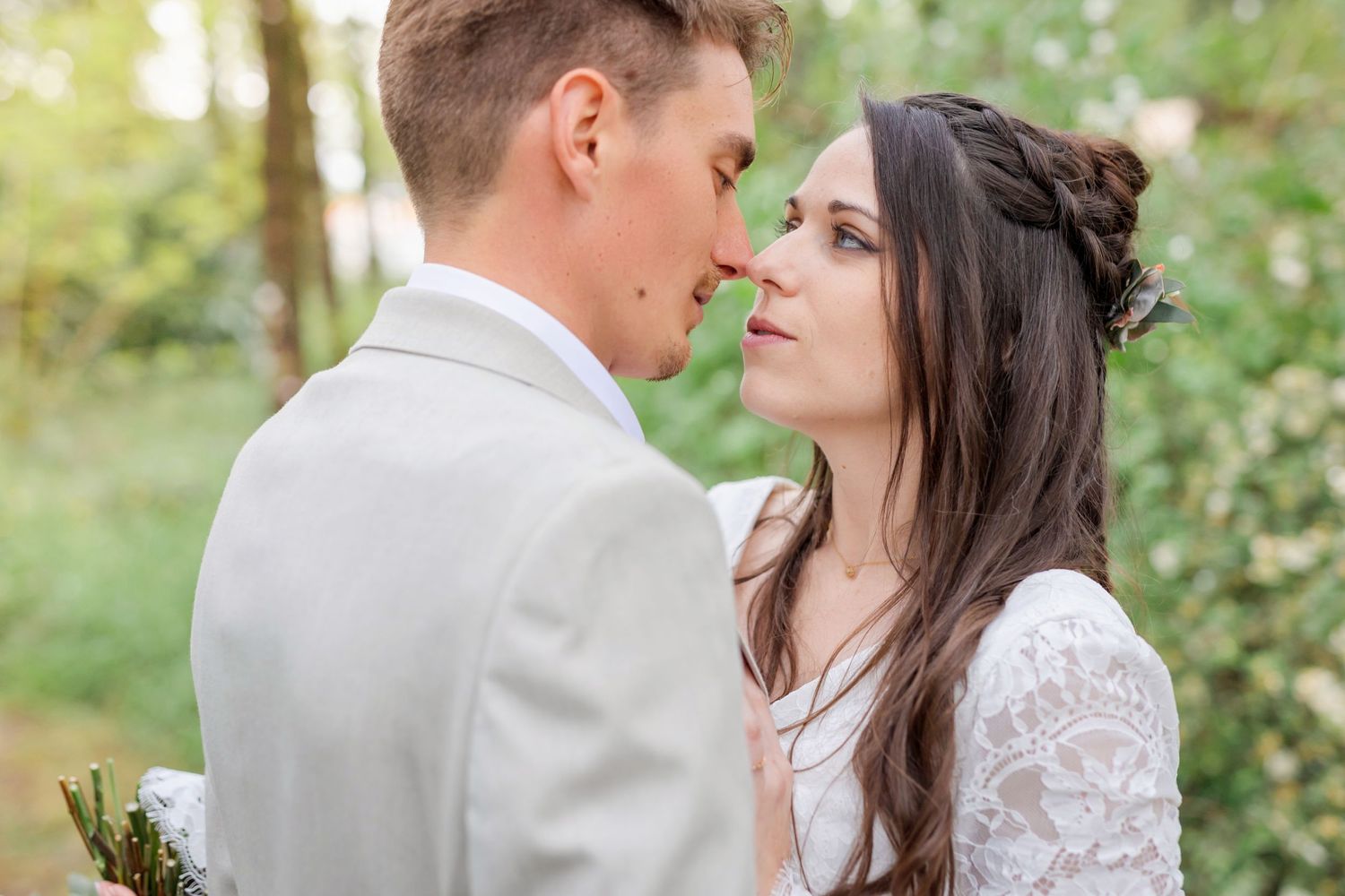 Romantic forest wedding portraits showing tender moments between newlyweds.