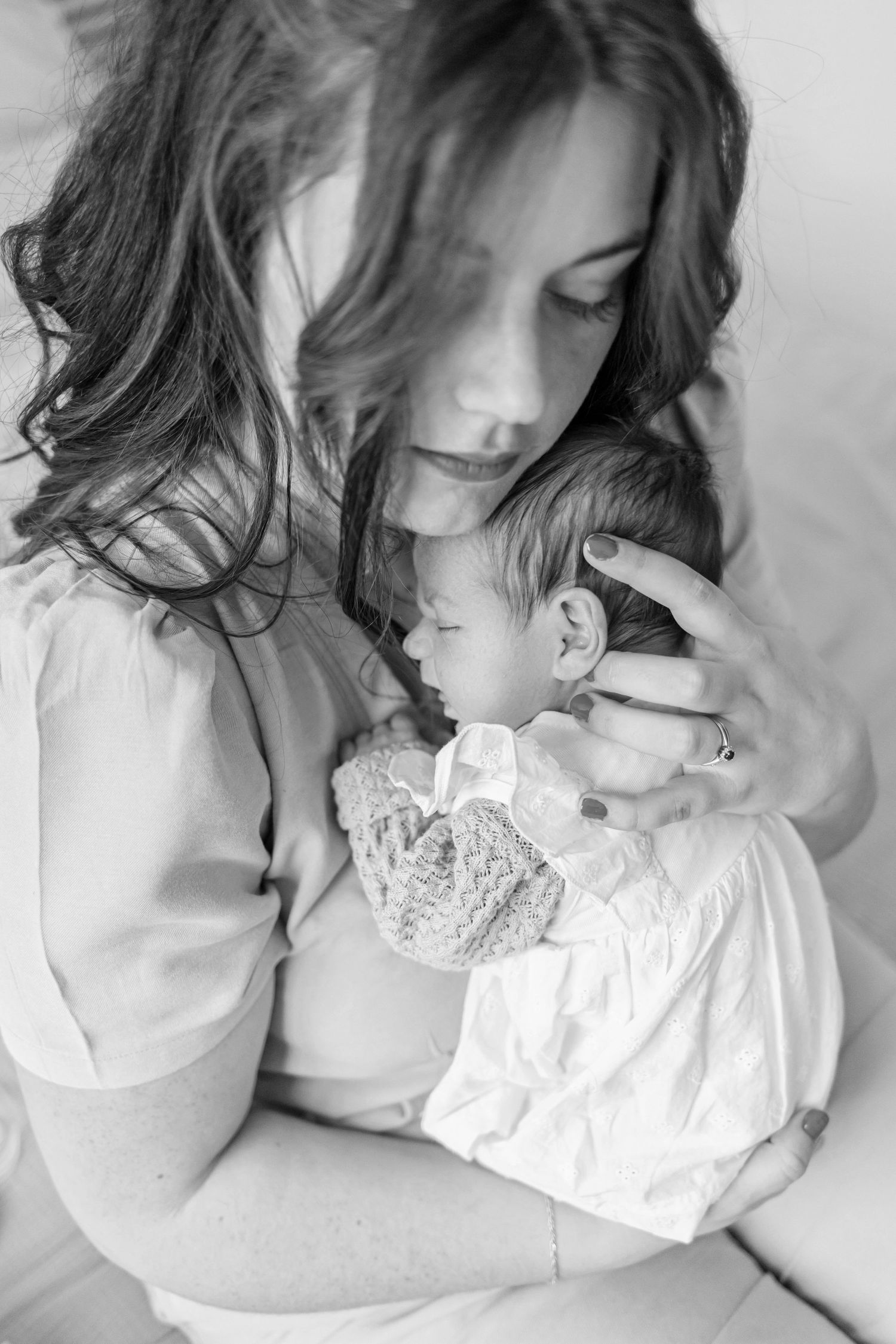 A black and white intimate portrait showing a tender embrace and gentle care.