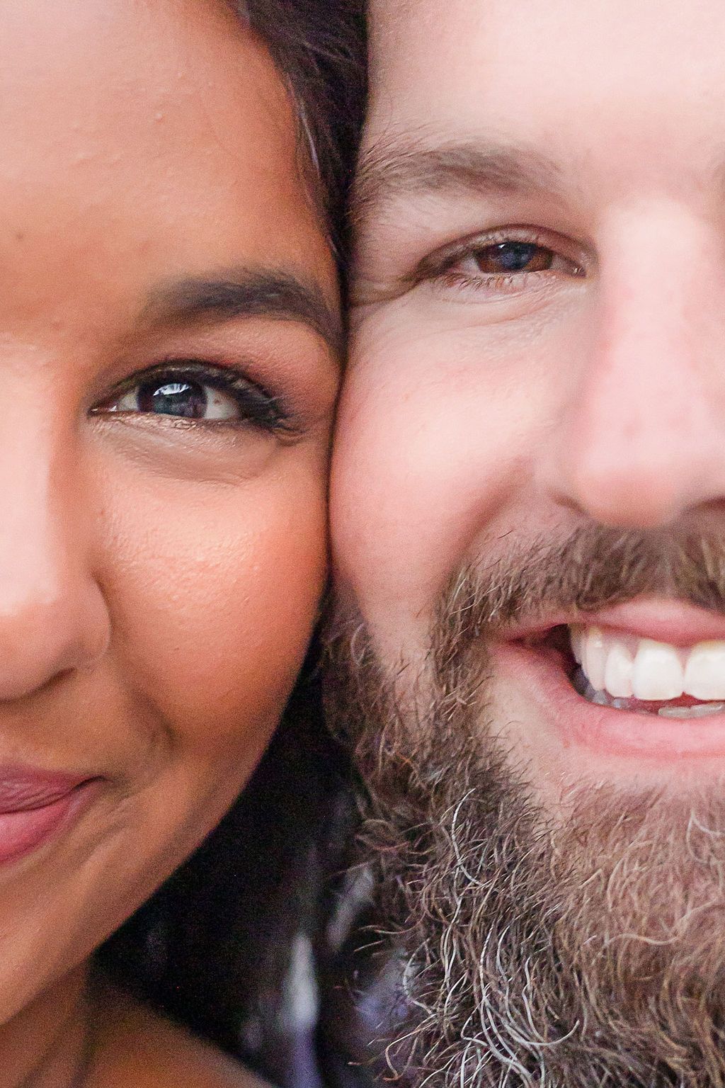 Closeup portrait showing smiling faces and partial facial features.