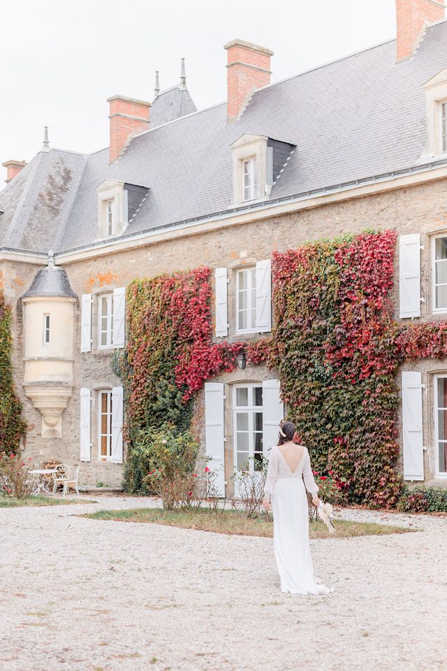 Stately French manor house with red ivy-covered walls and grey slate roof.