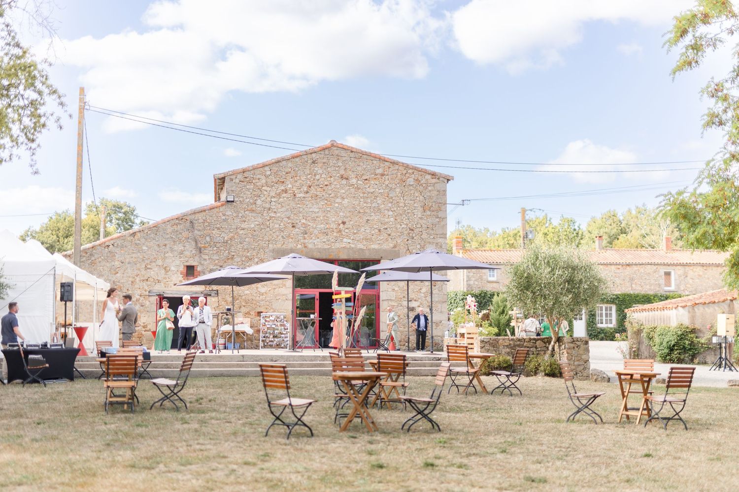 Rustic outdoor venue setup with wooden chairs and natural landscape.