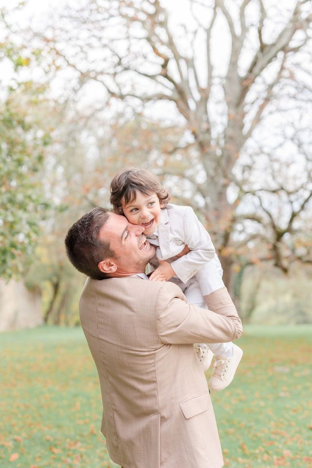 Happy outdoor portrait showing pure joy against autumn trees and greenery.