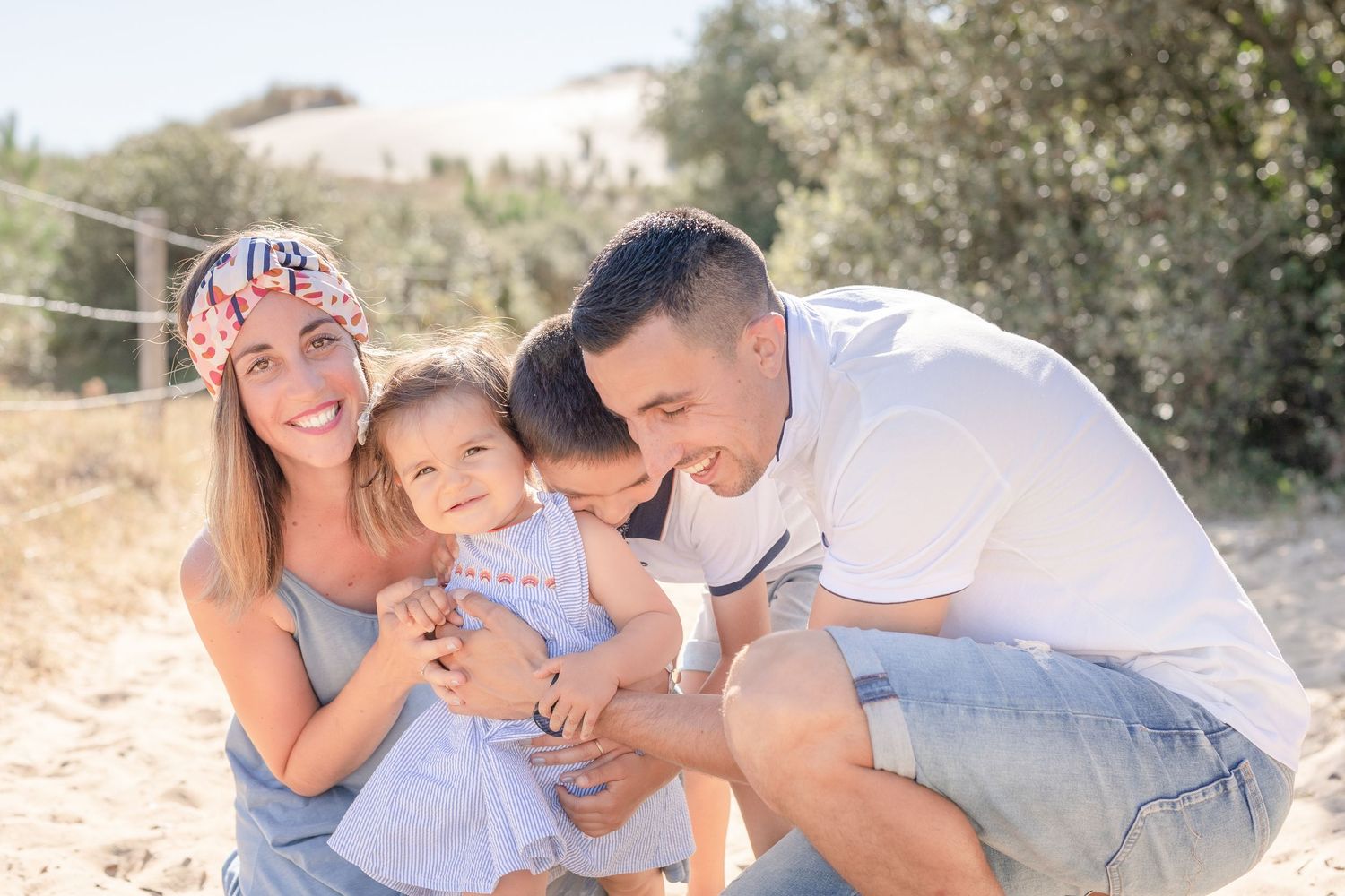 Candid family moments captured while playing on a sandy beach path.