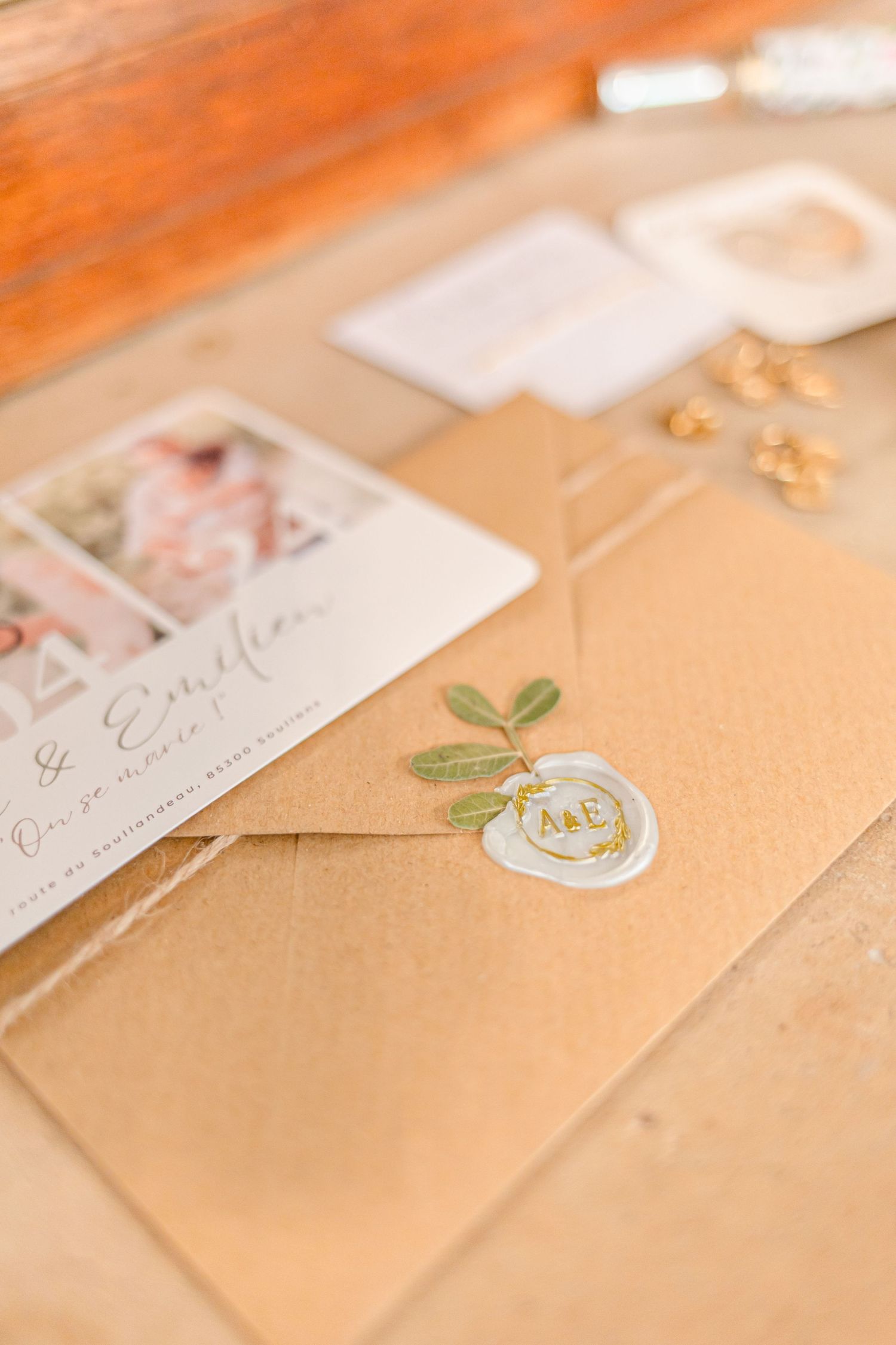 Elegant kraft paper envelope with floral wax seal and wedding stationery.