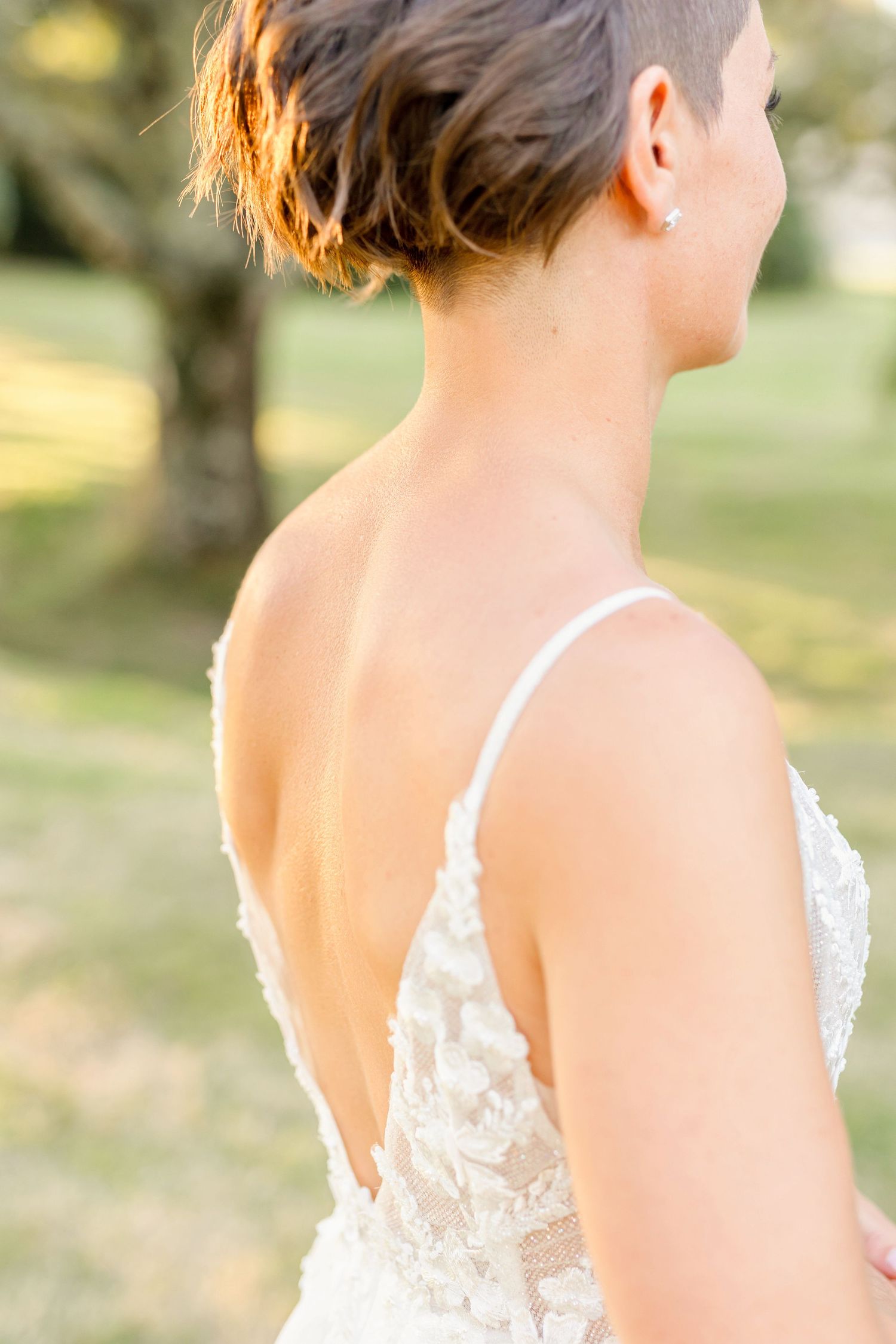 Back view of a wedding dress showing elegant lace straps and plunging V-cut design.