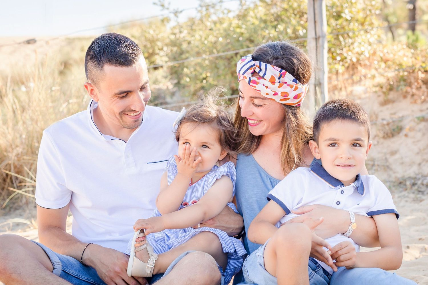 Lifestyle family photography with everyone in coordinated blue and white attire.