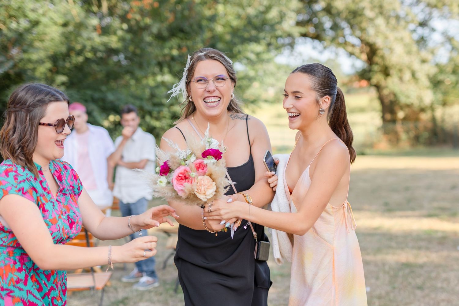 Candid moments of celebration captured during outdoor wedding festivities.