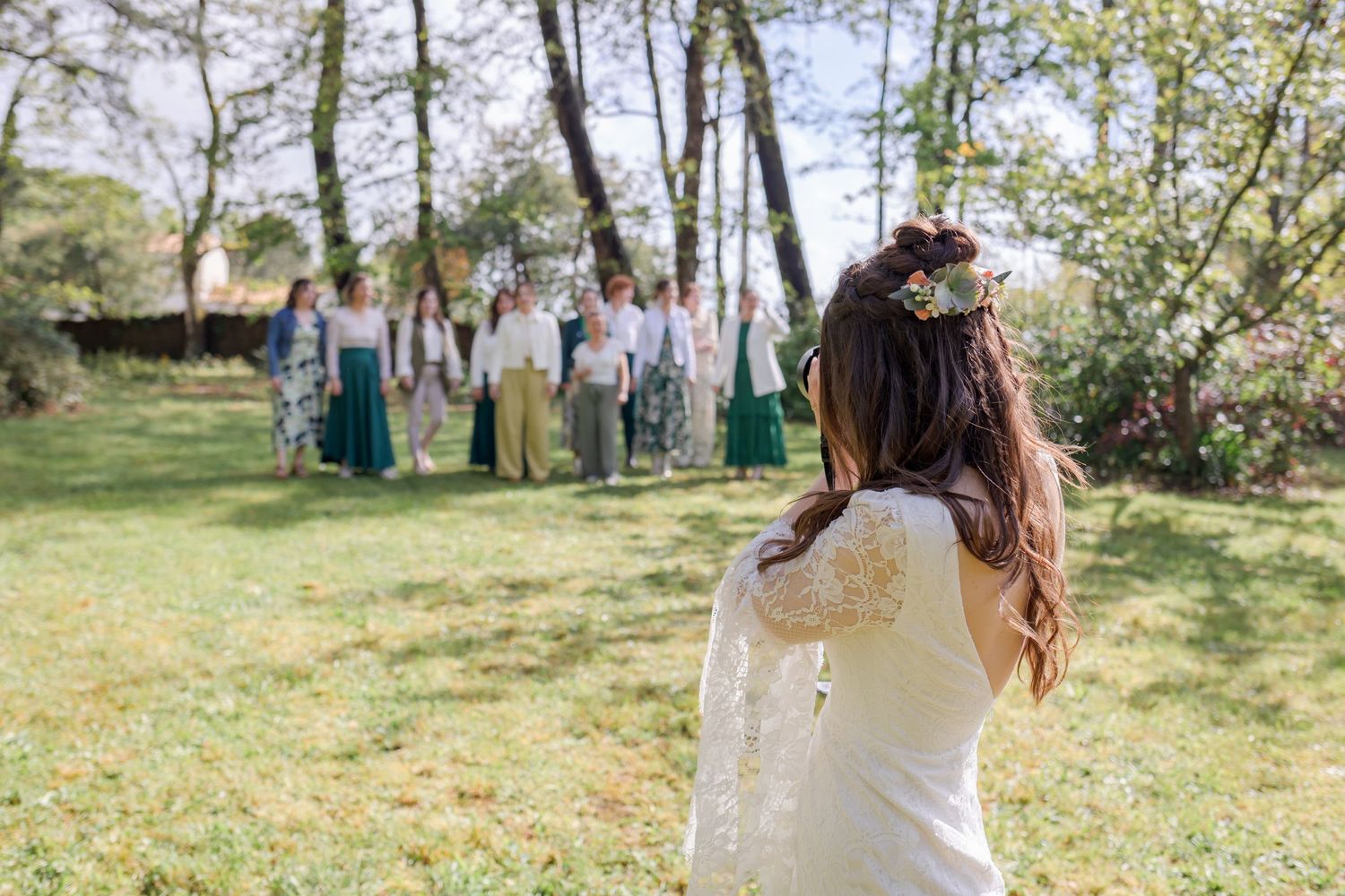 Wedding scene in a sun-dappled forest with natural outdoor lighting.