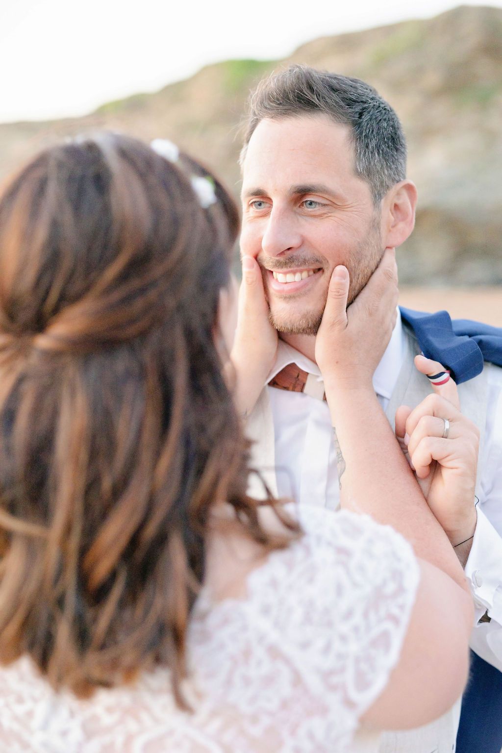A tender romantic moment captured during a beach wedding photoshoot.