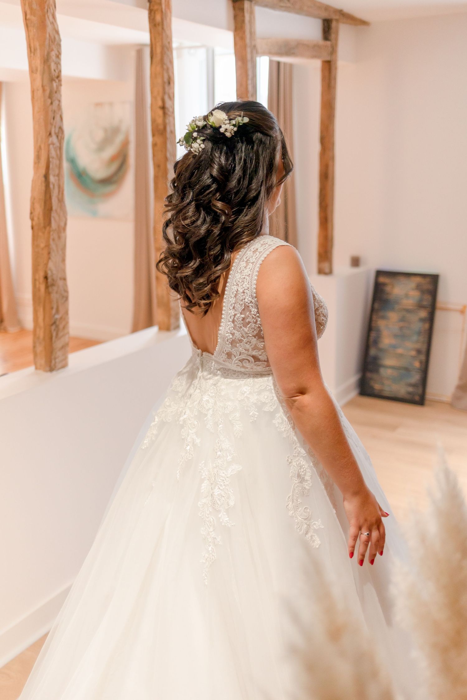 Bride twirling in a white lace ballgown wedding dress with tulle skirt.