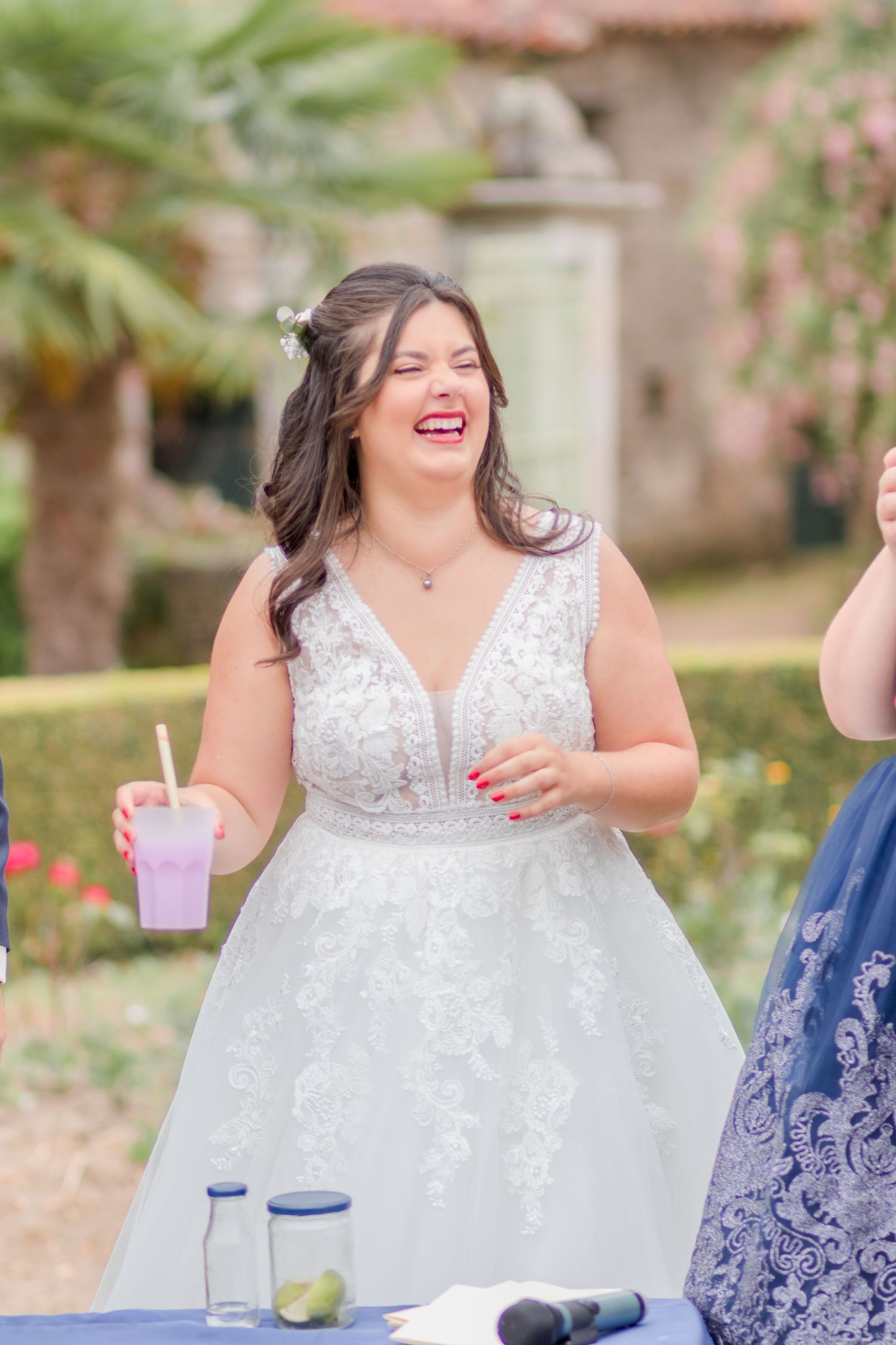 Candid moments of bridesmaids laughing and enjoying beverages at an outdoor wedding reception.