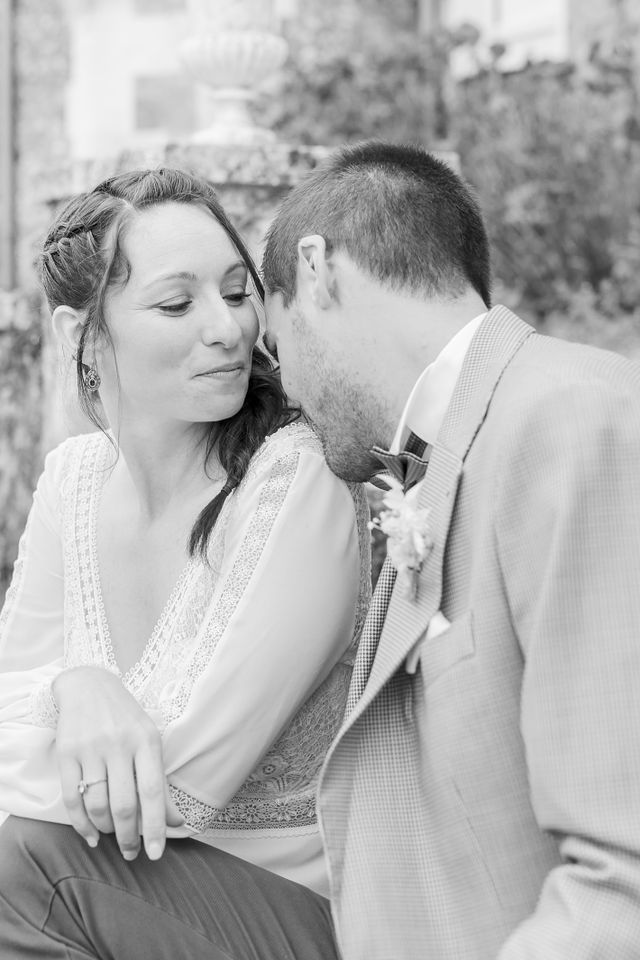 A tender black and white wedding portrait capturing an intimate moment between newlyweds.
