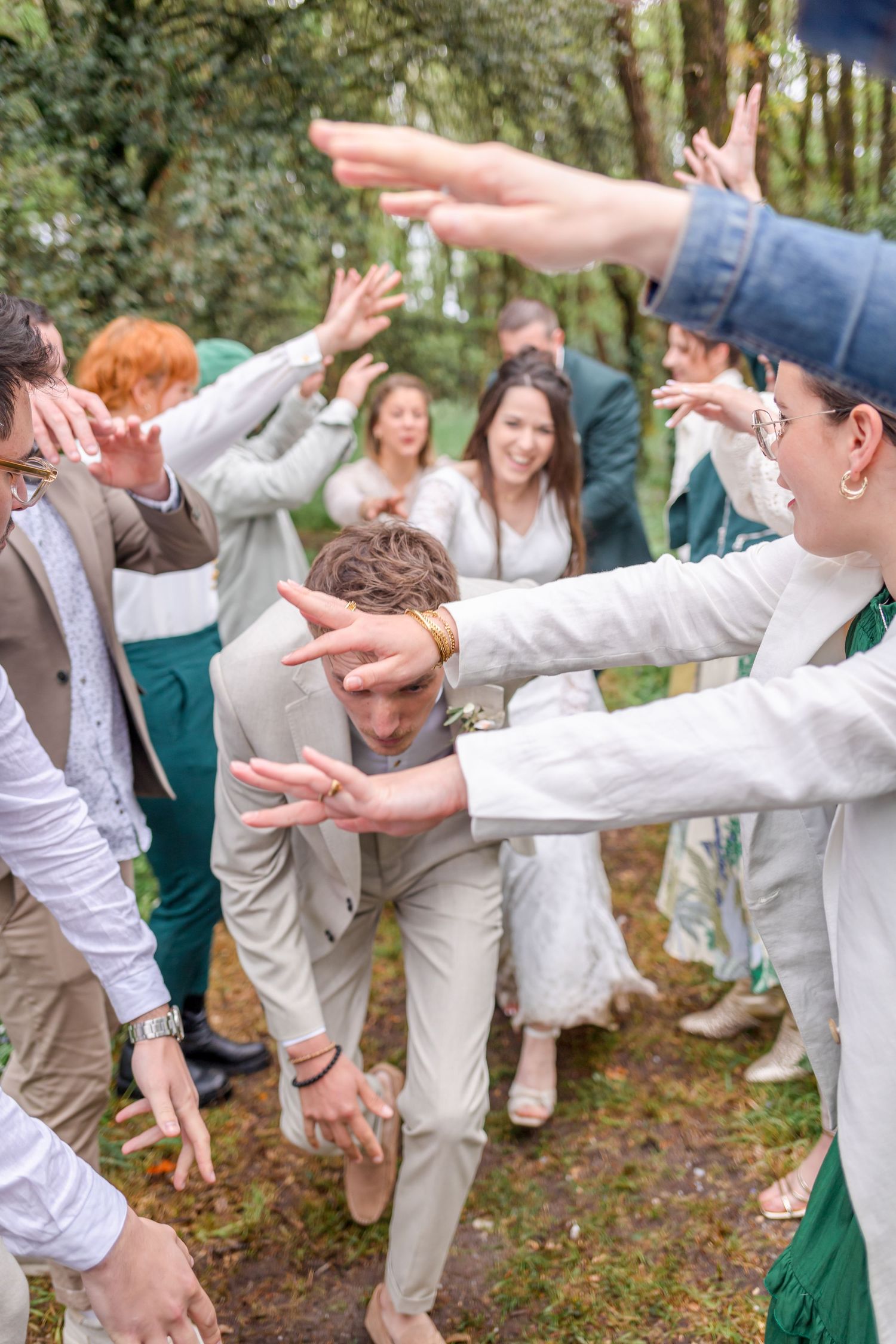 Celebratory dance moves and playful interactions at an outdoor wedding party.