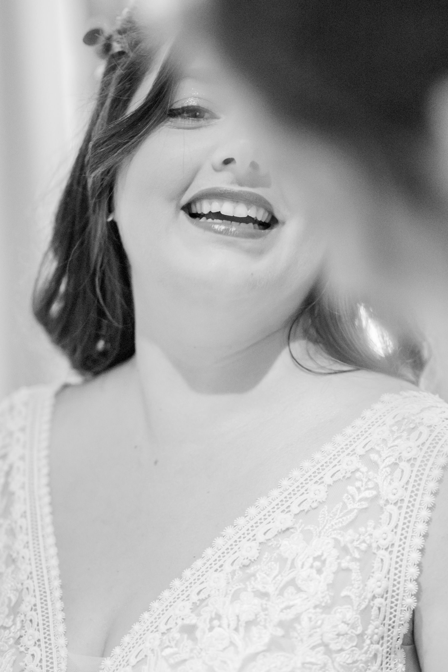 Black and white close-up detail of lace wedding dress bodice.