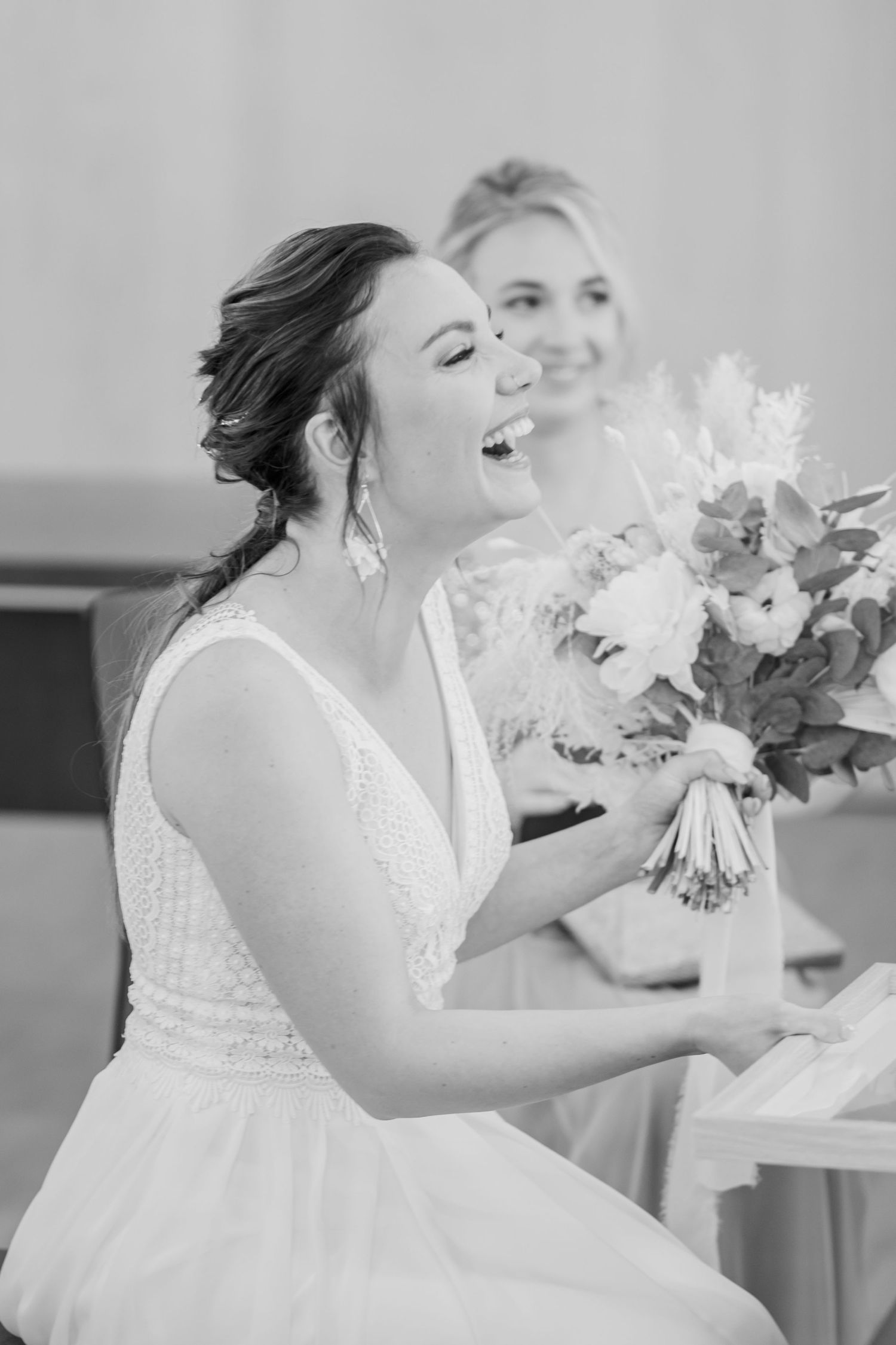 Black and white photo of joyful moments with wedding bouquets.