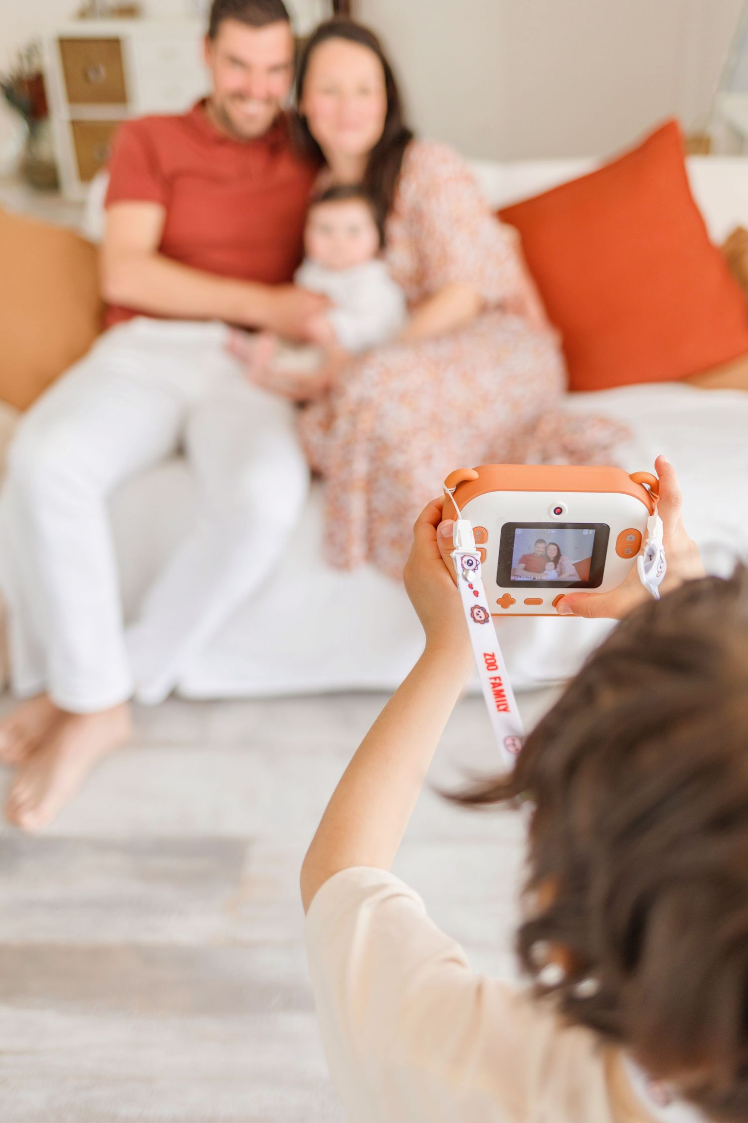 Capturing memories on a smartphone during intimate family photoshoot.