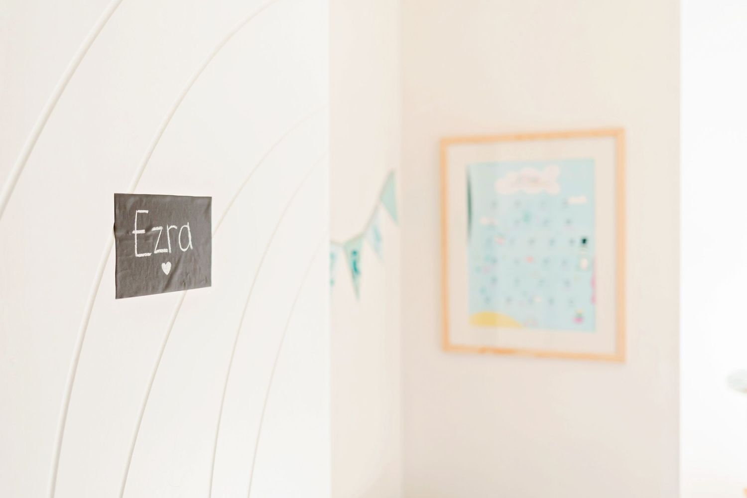 Blurred wall art and signage in a bright minimalist interior.