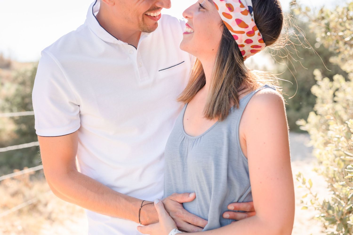Romantic sunset portraits showing tender moments between a couple on the beach.